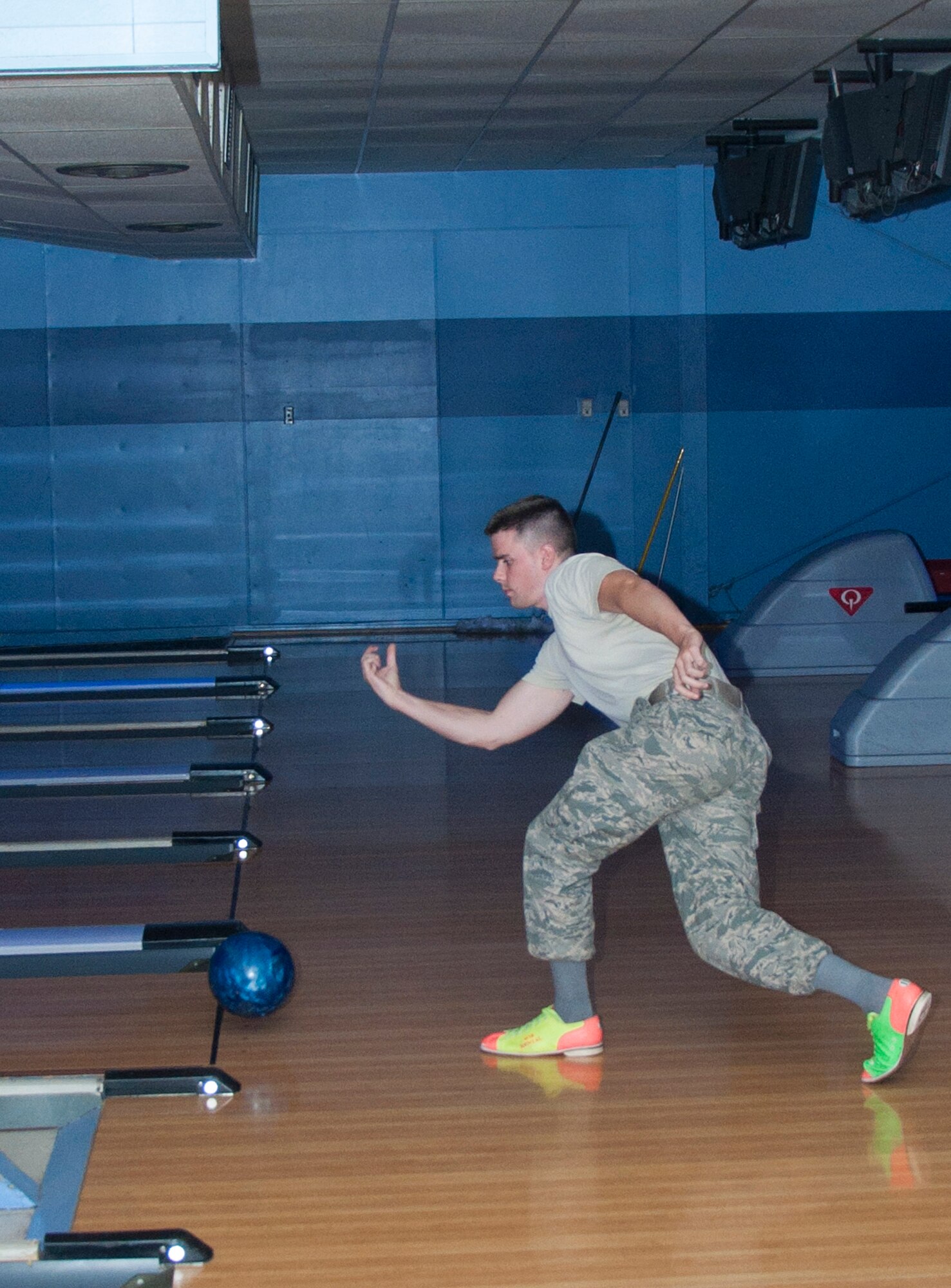 131017-F-GZ967-022 Senior Airman Adam Tallman, 90th Missile Maintenance Squadron, slides into the end of his motion as he sends his bowling ball down the lane as he competes in the “Strike Out Domestic Violence” bowling tournament at the Warren Lanes Oct. 17. (U.S. Air Force photo by Airman 1st Class Brandon Valle)