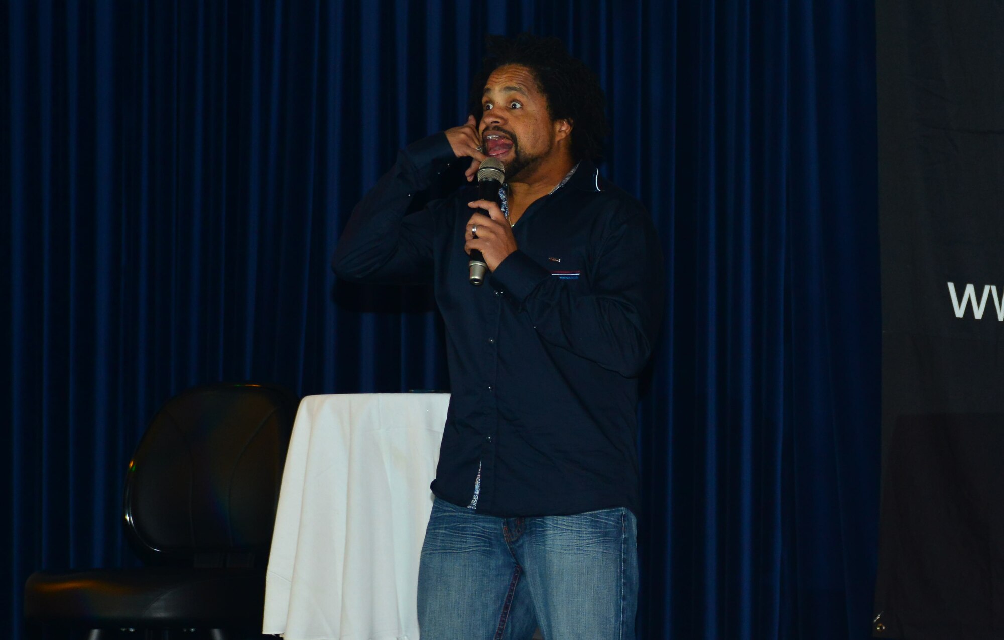 Comedian Vargus Martin acts out a skit for members of Team Incirlik Oct. 21, 2013, at Incirlik Air Base, Turkey.  Team Incirlik had the opportunity to enjoy jokes and skits during the “Funny Ladies and Vargus” tour around Eastern Europe. (U.S. Air Force photo by Staff Sgt. Eric Summers Jr./Released)