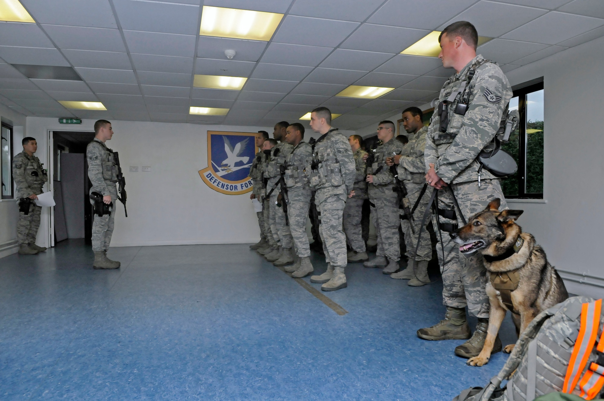 U.S. Air Force Staff Sgt. Barret Chappelle, 100th Security Forces Squadron Military Working Dog handler from Lafayette, La., and MWD Zulton attend guard mount Oct. 11, 2013, on RAF Mildenhall, England. The MWDs are viewed as partners by their handlers, not as pets. Handlers conduct various training exercises around base to keep their MWDs proficient. (U.S. Air Force photo by Senior Airman Christine Griffiths/Released)