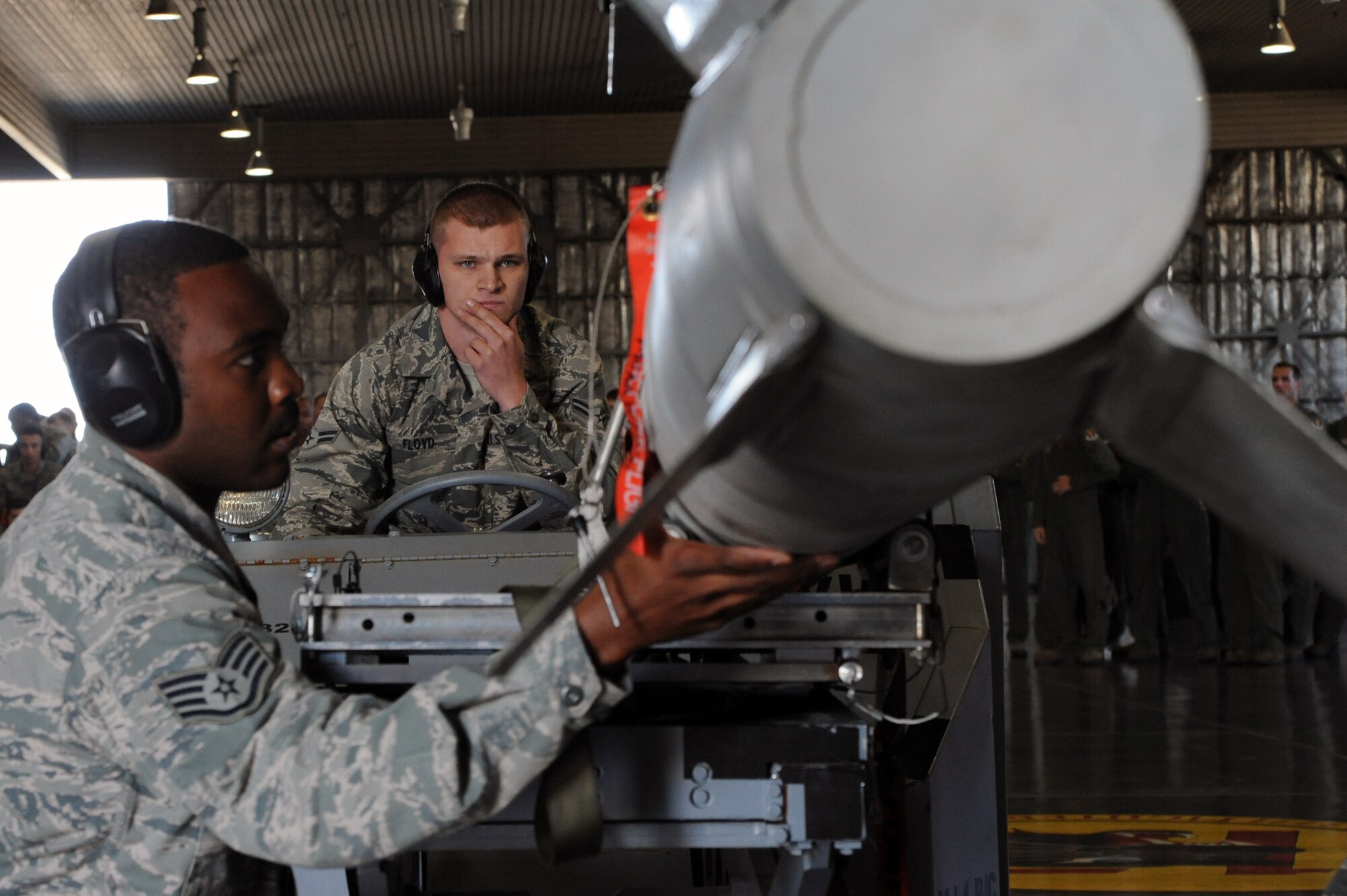 U.S. Air Force Staff Sgt. Ryan Baldwin, left, 13th Aircraft Maintenance Unit weapons load team chief, utilizes the help of Airman 1st Class Devin Floyd, 13 AMU load crew member, while loading an AGM-88 High-speed Anti-radiation Missile during the Load Crew of the Quarter competition at Misawa Air Base, Japan, Oct. 18, 2013. The three-man team of the 13 AMU finished with a load time under 16 minutes, their fastest together as a team. (U.S. Air Force photo by Senior Airman Derek VanHorn)