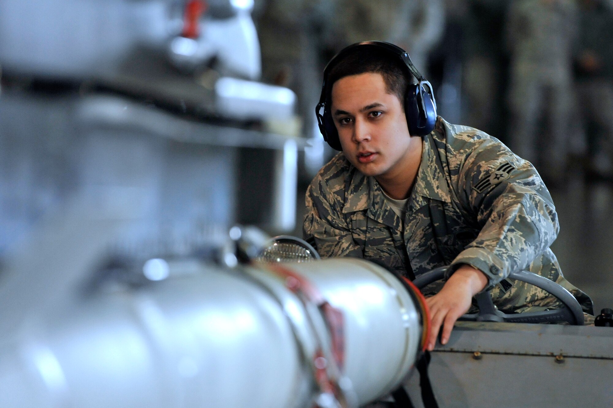 U.S. Air Force Senior Airman Ian Franco Reyes, 14th Aircraft Maintenance Unit load crew member, looks on from a MJ-1 lift truck during the Weapons Load Crew of the Quarter competition at Misawa Air Base, Japan, Oct. 18, 2013. The MJ-1, known as the “jammer”, has the capacity to lift 3,000 pounds and is used to load and unload a variety of munitions. (U.S. Air Force photo by Airman 1st Class Zachary Kee)