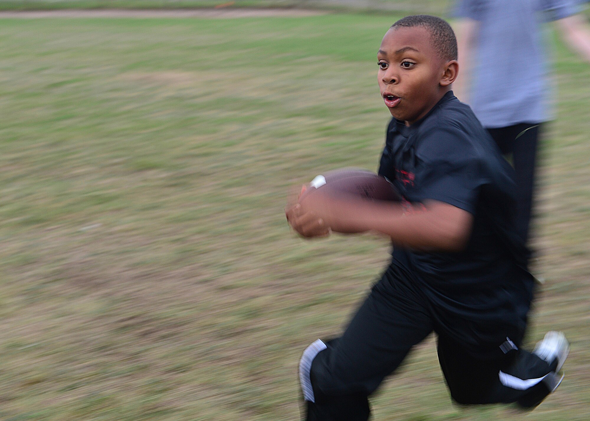Katrell Tyre, 12, running back with the Leopards youth football team and son of Tech. Sgt. DeJuan Tyre, 100th Civil Engineer Squadron NCO in charge of heating, ventilation and air conditioning, runs during practice at Royal Air Force Lakenheath, England, Sept. 11, 2013. The Youth Sports Program offers children aged 5 to 18 a wide array of organized activities to help children develop desired physical skills, to mature emotionally and socially, and to learn the importance of teamwork. (U.S. Air Force photo by Staff Sgt. Stephanie Mancha/Released)