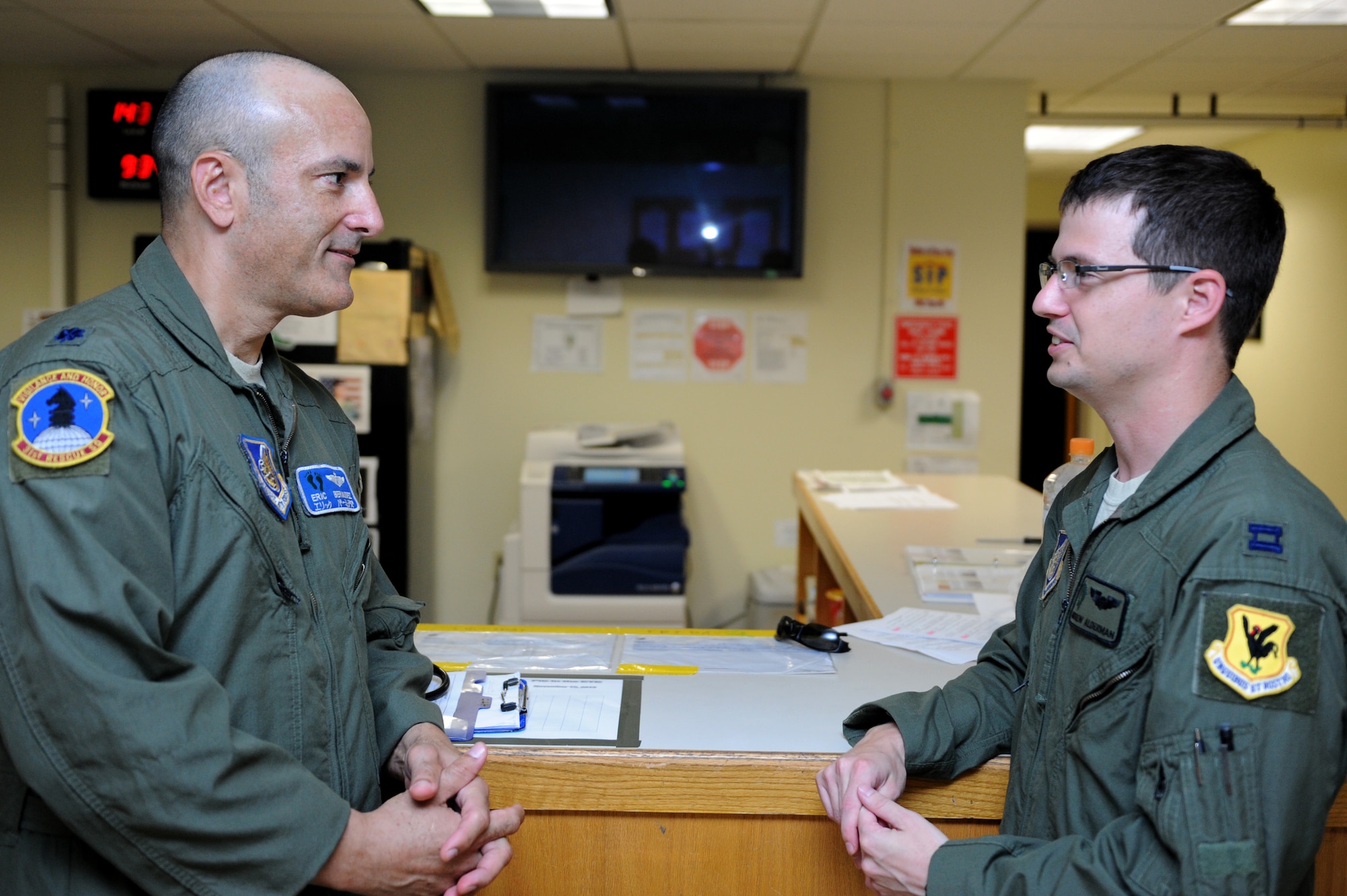 U.S. Air Force Lt. Col. James Bermudez, 31st Rescue Squadron flight surgeon, and Capt. Andrew Alderman, 33rd Rescue Squadron pilot, talk about their weekend during a routine visit to the squadron on Kadena Air Base, Japan, Oct. 21, 2013. Bermudez, one of five active flight surgeons assigned to Kadena, visits each flying squadron on a regular basis to interact with Airmen on active flight status. By interacting with aircrew, Bermudez has a unique opportunity to learn more about his patients on a one-on-one basis and identify health concerns before they become a bigger issue and affect Kadena?s flying mission. (U.S. Air Force photo by Airman 1st Class Hailey R. Davis)