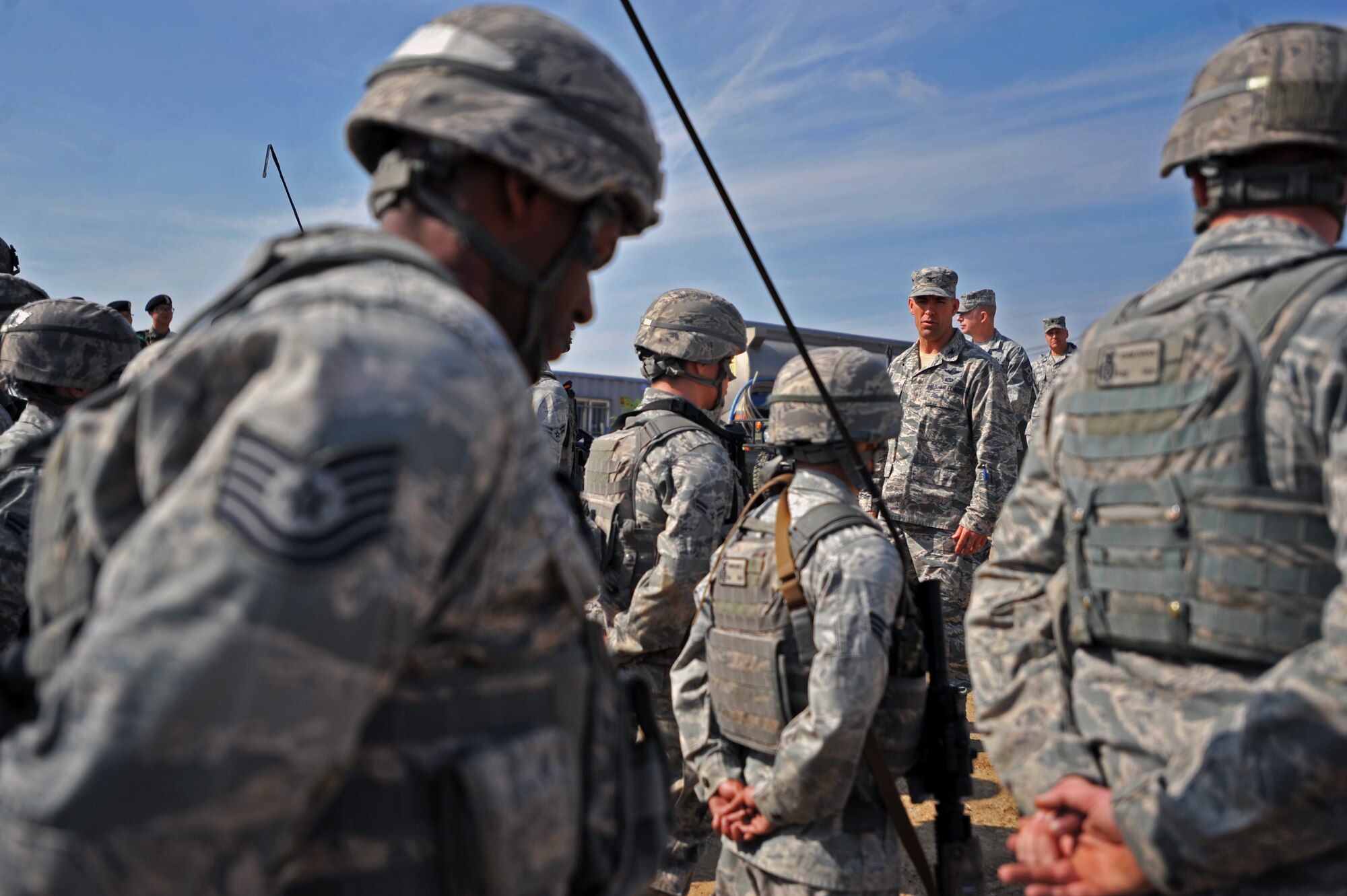 Col. Brook Leonard, 51st Fighter Wing commander, briefs members of the 51st Security Forces Squadron during a field training exercise at Osan Air Base, Republic of Korea, Oct. 17, 2013. Leonard was able to witness firsthand the 51st SFS’s combat abilities during a training scenario where the defenders faced off against opposition forces role players. (U.S. Air Force photo/Senior Airman Siuta B. Ika)