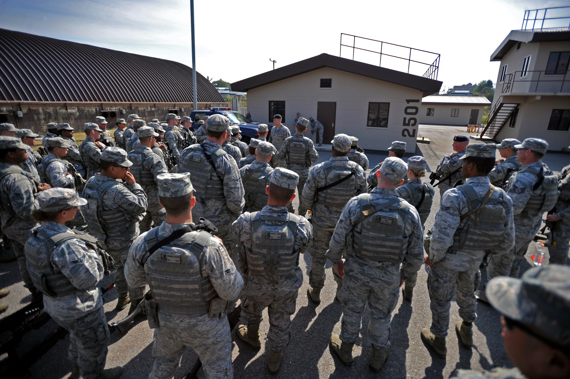 Members of the 51st Security Forces Squadron listen to a briefing from a joint terminal attack controller during a field training exercise at Osan Air Base, Republic of Korea, Oct. 17, 2013. During one of the training scenarios, the 51st SFS practiced calling in close air support to aid them in expelling opposition forces role players. (U.S. Air Force photo/Senior Airman Siuta B. Ika)