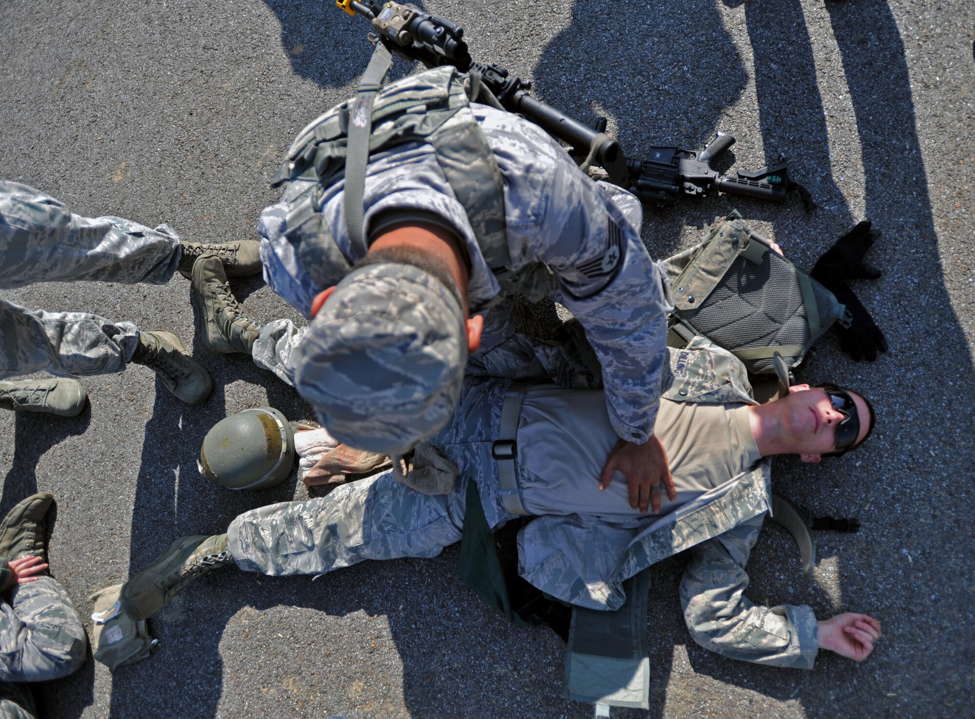 Staff Sgt. Darryl Thompson, 51st Security Forces Squadron fire team leader, conducts a body check during a field training exercise at Osan Air Base, Republic of Korea, Oct. 17, 2013. Before facing off with opposition forces role players, the fire teams took refresher training on self-aid and buddy care, dead body searches and intelligence gathering. (U.S. Air Force photo/Senior Airman Siuta B. Ika)