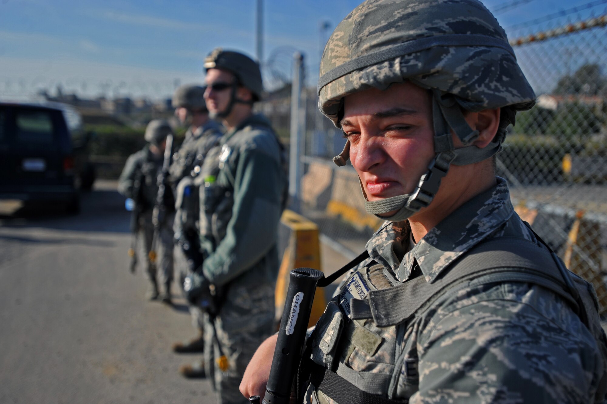 Members of the 51st Security Forces Squadron stand guard during a protest scenario at Osan Air Base, Republic of Korea, Oct. 17, 2013. This scenario was the first of many the defenders would encounter throughout the two-day field training exercise. (U.S. Air Force photo/Senior Airman Siuta B. Ika)