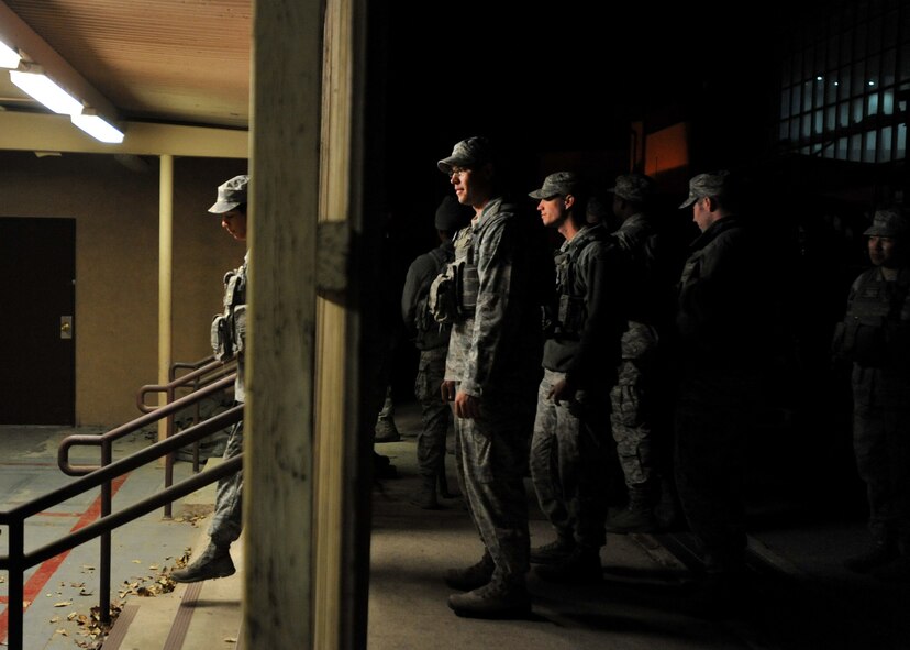 Members of the 51st Security Forces Squadron wait to be issued weapons outside of the armory during a field training exercise at Osan Air Base, Republic of Korea, Oct. 17, 2013. The defenders participated in multiple training scenarios throughout the two-day exercise that were designed to prepare them to fight and win against any adversary. (U.S. Air Force photo/Senior Airman Siuta B. Ika)