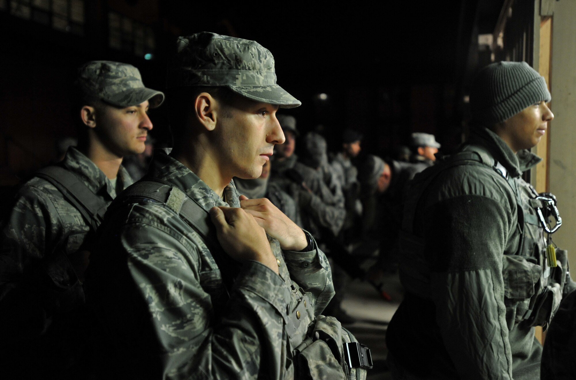 Members of the 51st Security Forces Squadron wait to be issued weapons outside of the armory during a field training exercise at Osan Air Base, Republic of Korea, Oct. 17, 2013. Throughout the exercise, the defenders utilized all of the weapons at their disposal, including the M-240 machine gun. (U.S. Air Force photo/Senior Airman Siuta B. Ika)