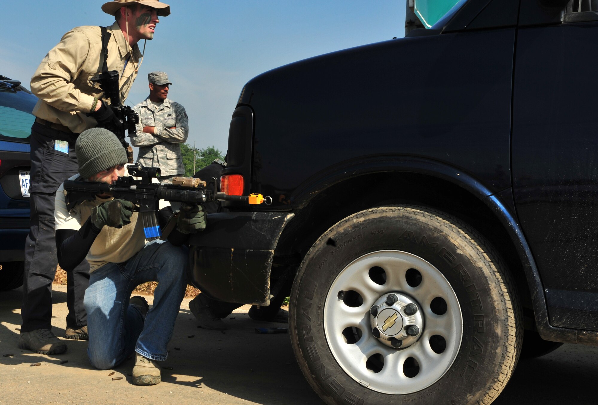 Members of the 51st Security Forces Squadron use a vehicle for cover during a field training exercise at Osan Air Base, Republic of Korea, Oct. 17, 2013. The scenario involved an attempt by participants disguised as insurgents to infiltrate the base. (U.S. Air Force photo/Airman 1st Class Ashley J. Thum)