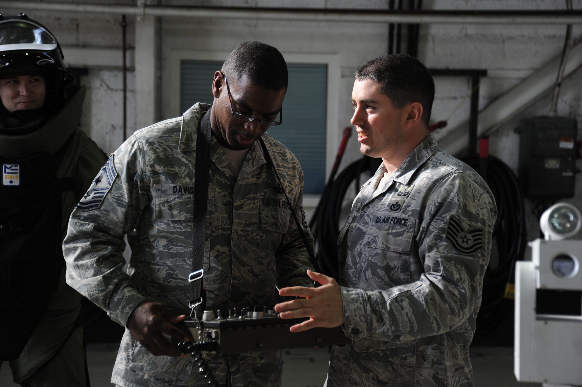 SPANGDAHLEM AIR BASE, Germany --- Chief Master Sgt. James Davis, U.S. Air Forces in Europe and Air Forces Africa command chief, left, learns how to operate the controls of a bomb disposal robot from Tech. Sgt. Jeffrey Polley, 52nd Civil Engineer Squadron explosive ordnance technician, during a tour Oct. 18, 2013. The chief toured Spangdahlem along with Gen. Frank Gorenc, USAFE/AF Africa commander. (U.S. Air Force photo by Senior Airman Joe W. McFadden / Released)