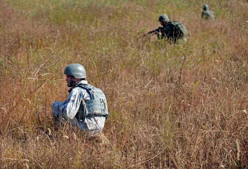 A member of the 51st Security Forces Squadron kneels during a field training exercise near the perimeter of Osan Air Base, Republic of Korea, Oct. 18, 2013. Members of the ROK army 51st Special Forces Battalion also participated in the training as both fire team members and as opposition forces role players. (U.S. Air Force photo/Senior Airman Siuta B. Ika)