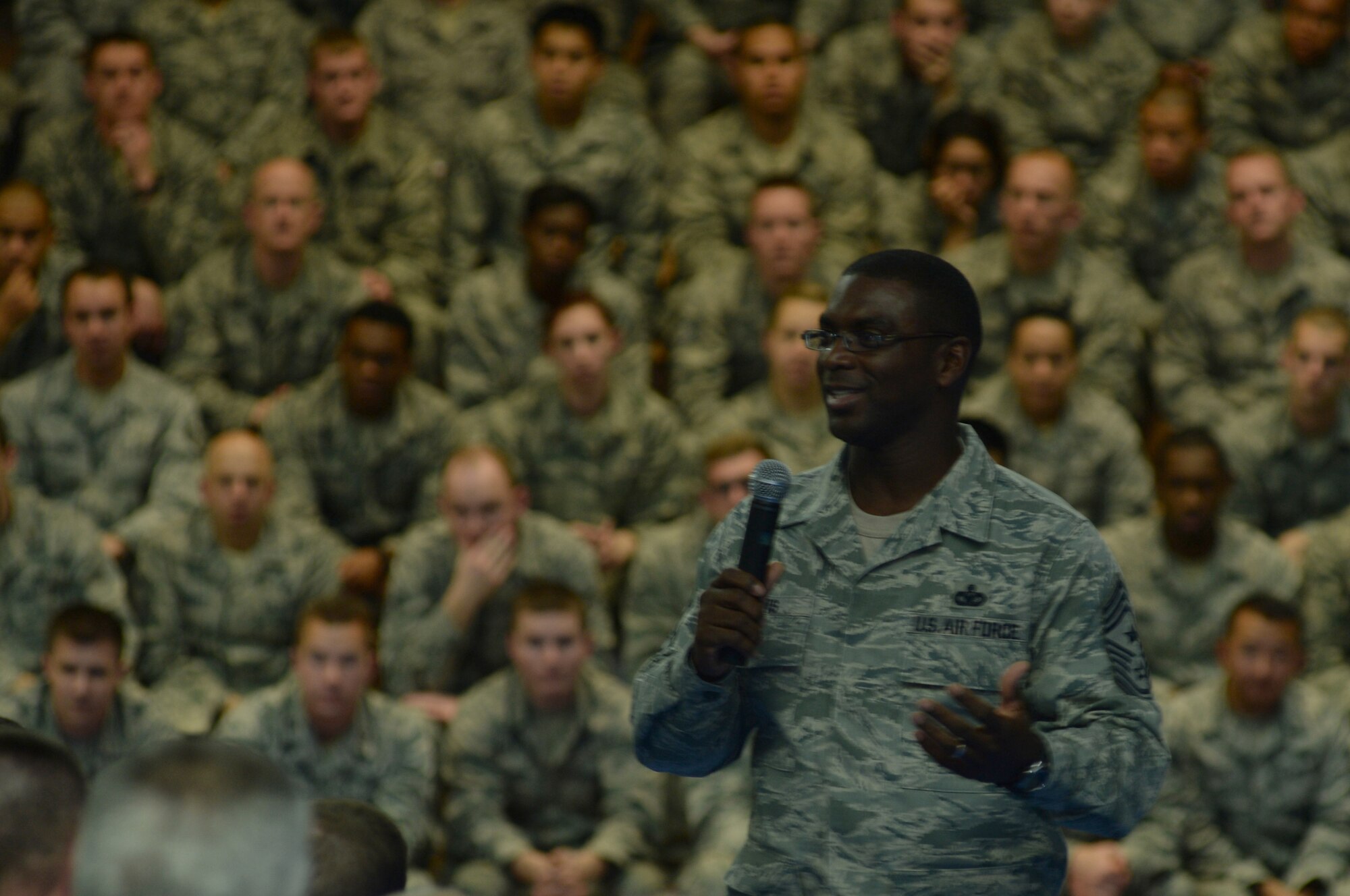SPANGDAHLEM AIR BASE, Germany --- Chief Master Sgt. James Davis, U.S. Air Forces in Europe and Air Forces Africa command chief, answers a question during a wing all-call at the Skelton Memorial Fitness Center Oct. 18, 2013. As USAFE command chief, Davis champions and directs enlisted theater security engagement and building partnership capacity in an area of responsibility that comprises 104 countries in support of both U.S. European Command and U.S. Africa Command. (U.S. Air Force photo by Senior Airman Joe W. McFadden / Released)