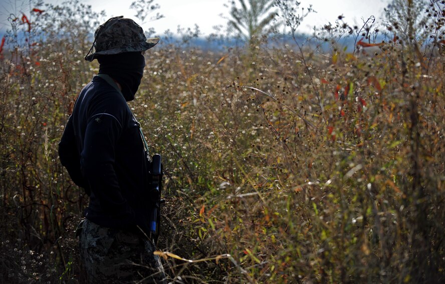 A member of the Republic of Korea army 51st Special Forces Battalion waits to ambush members of the 51st Security Forces Squadron during a field training exercise near the perimeter of Osan Air Base, ROK, Oct. 18, 2013. The ROKA special forces members took turns acting as responding fire teams members and as opposition forces role players. (U.S. Air Force photo/Senior Airman Siuta B. Ika)
