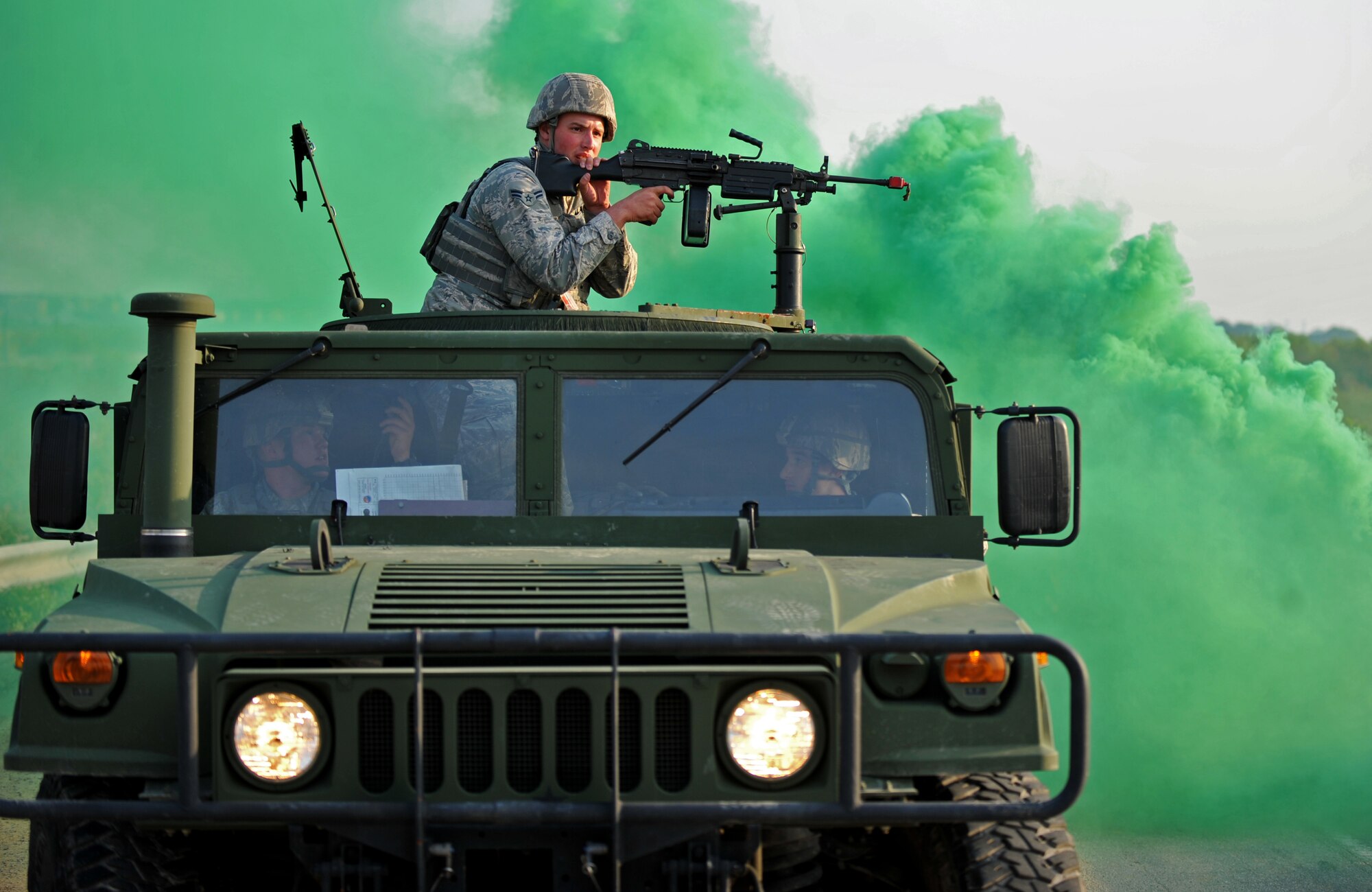 A 51st Security Forces Squadron fire team responds to a mortar threat during a field training exercise near the perimeter of Osan Air Base, Republic of Korea, Oct. 17, 2013. The green smoke represented an improvised explosive device blast, which disabled the defenders’ tactical vehicle. (U.S. Air Force photo/Senior Airman Siuta B. Ika)