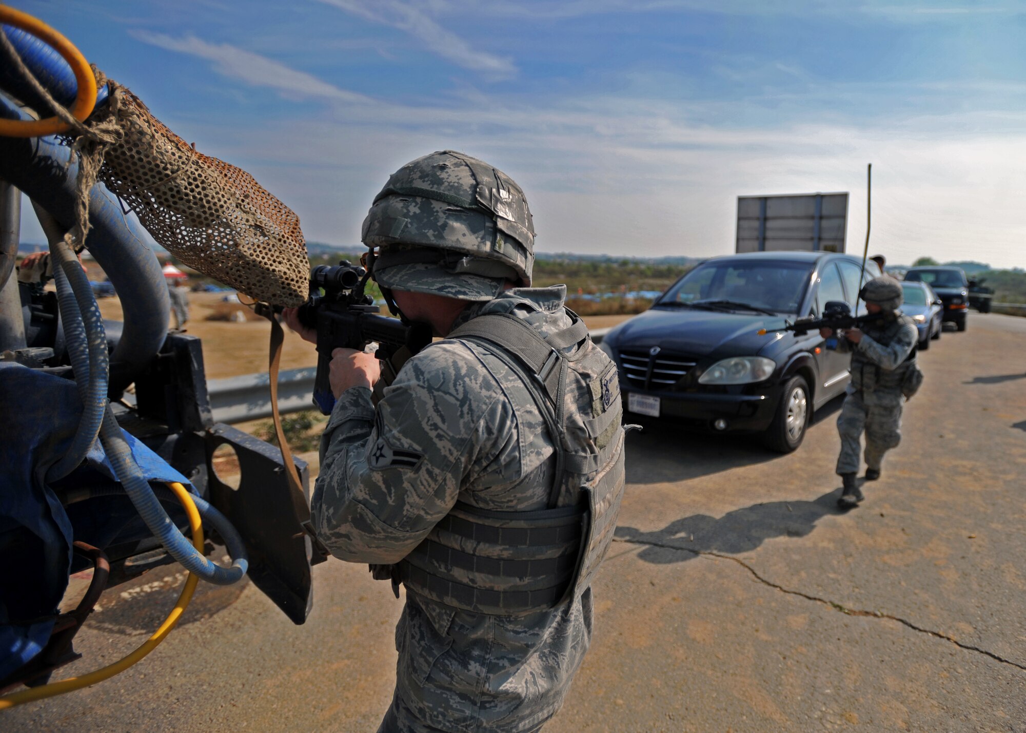 Airman 1st Class Kenneth Latchford, 51st Security Forces Squadron fire team member, lays down cover fire for another member of his team during a field training exercise near the perimeter of Osan Air Base, Republic of Korea, Oct. 17, 2013. During the scenario, defenders were able to practice multiple battle tactics and call in close air support. (U.S. Air Force photo/Senior Airman Siuta B. Ika)