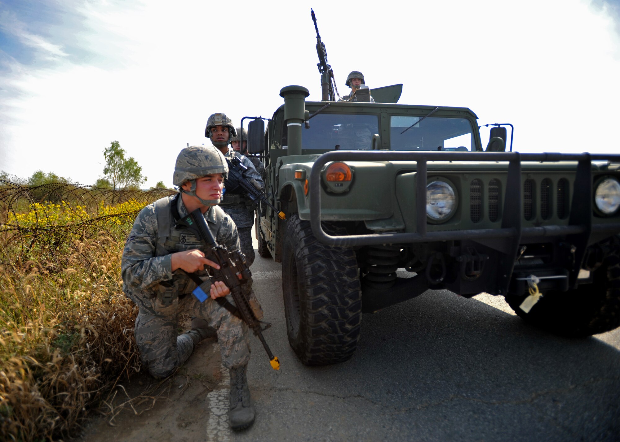 Members of the 51st Security Forces Squadron respond to a mortar threat during a field training exercise near the perimeter of Osan Air Base, Republic of Korea, Oct. 17, 2013. After exiting their tactical vehicle, defenders encountered small arms fire and simulated improvised explosive device blasts. (U.S. Air Force photo/Senior Airman Siuta B. Ika)