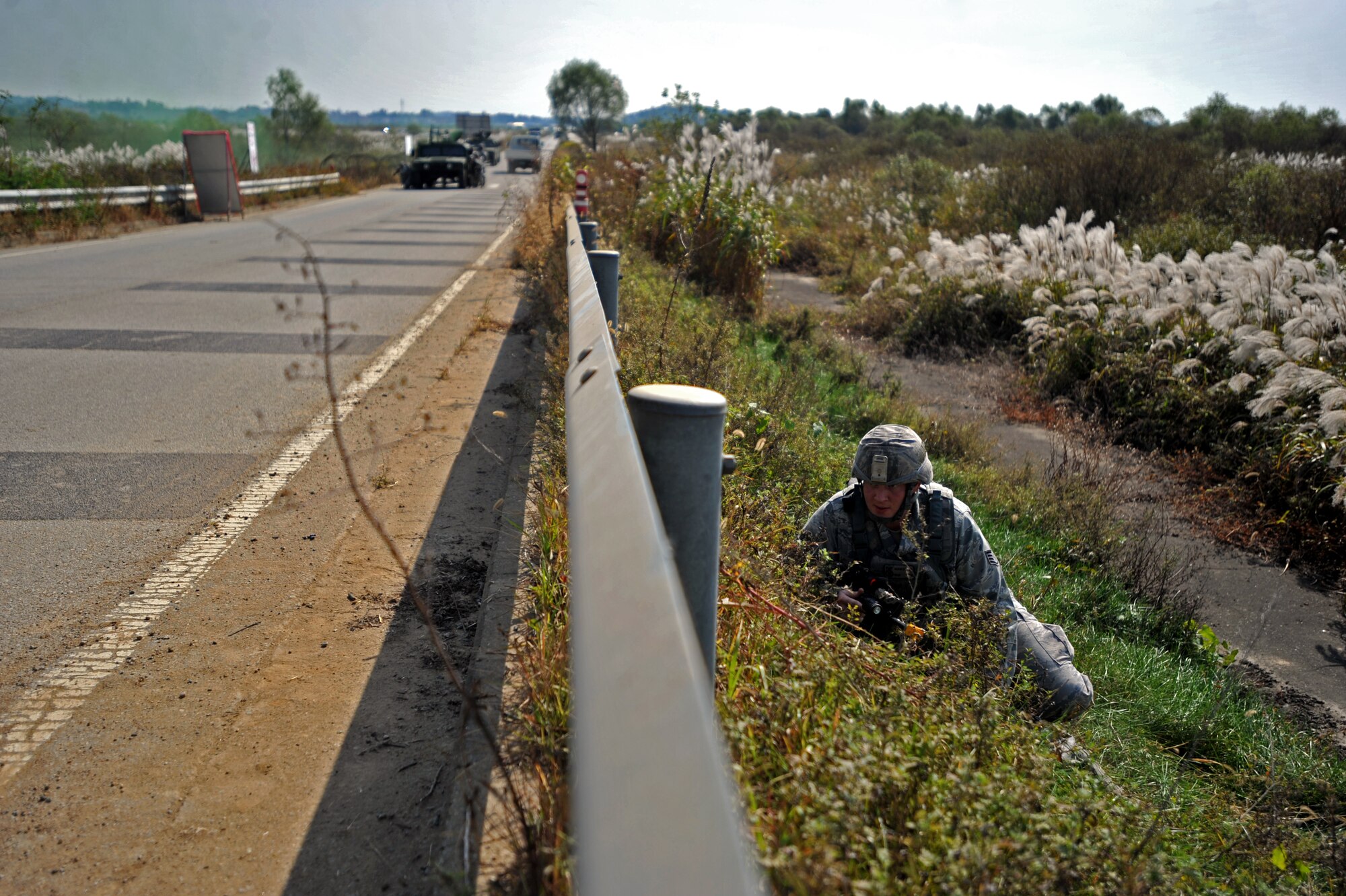 Staff Sgt. Adam Dodge, 51st Security Forces Squadron fire team leader, attempts to make his way back to his convoy during a field training exercise near the perimeter of Osan Air Base, Republic of Korea, Oct. 17, 2013. Dodge and his team were the first defenders to engage the opposition forces after receiving intelligence that the OPFOR members were planning to attack the Osan flight line. (U.S. Air Force photo/Senior Airman Siuta B. Ika)