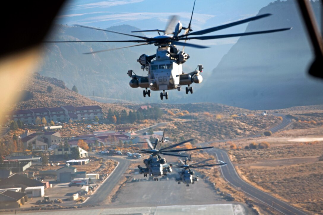 Marine Corps CH-53E Super Stallion helicopters lift off from the expeditionary airfield while conducting detachment operations during Mountain Exercise 6-13 at Marine Corps Mountain Warfare Training Center in Bridgeport, Calif., Oct 18, 2013.
