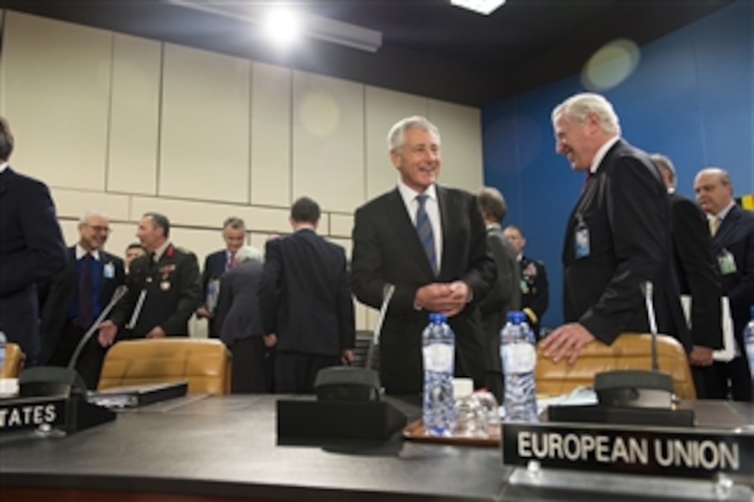 Secretary of Defense Chuck Hagel, left, speaks with Secretary General of the European External Action Service Pierre Vimont prior to the meeting of the North Atlantic Council at NATO headquarters in Brussels, Belgium, on Oct. 22, 2013.  Hagel will meet with NATO defense ministers to discuss post-2014 Afghanistan, prepare for next year’s NATO summit in the United Kingdom, and discuss the role of NATO in the coming years.   