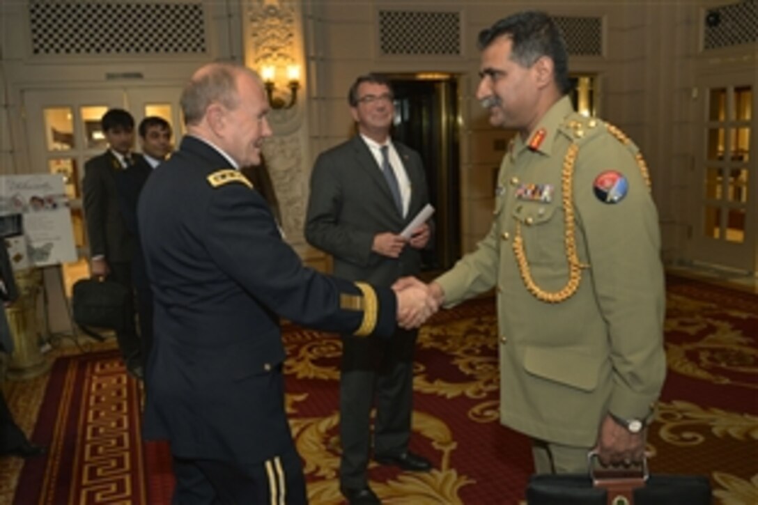 U.S. Army Gen. Martin E. Dempsey, left, chairman of the Joint Chiefs of Staff, shakes hands with a Pakistani military officer as he and U.S. Deputy Defense Secretary Ash Carter, center, arrive to meet with Pakistani Prime Minister Nawaz Sharif in Washington, D.C., Oct. 21, 2013. Carter and the prime minister met to discuss defense relations between the United States and Pakistan.