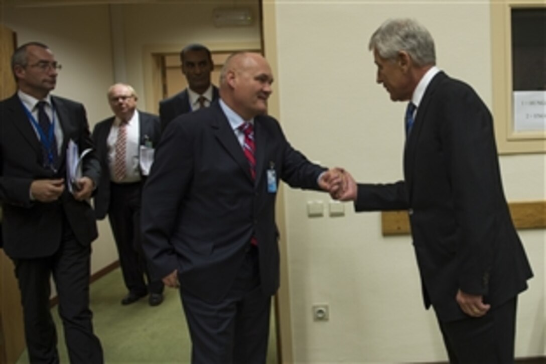 U.S. Defense Secretary Chuck Hagel, right, meets with Hungarian Defense MInister Csaba Hende at NATO headquarters in Brussels, Oct. 22, 2013.