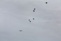 Marines with Air Delivery Platoon, Landing Support Company, 2nd Marine Logistics Group float through the air after exiting a MV-22B Osprey over Tactical Landing Zone Pheasant aboard Camp Lejeune, N.C., Oct. 21, 2013. The platoon used this exercise to renew their jump certifications and hone skills essential to mission readiness.(U.S Marine Corps photo by Lance Cpl. Shawn Valosin)