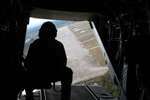 A Marine with Marine Medium Tiltrotor Squadron 365 gazes out of the rear of the plane after takeoff at Tactical Landing Zone Pheasant aboard Camp Lejeune, N.C., Oct. 21, 2013. The crew from VMM-365 flew from Marine Corps Air Station New River to assist Marines from Air Delivery Platoon, 2nd Marine Logistics Group with their exercise. (U.S Marine Corps photo by Lance Cpl. Shawn Valosin) 