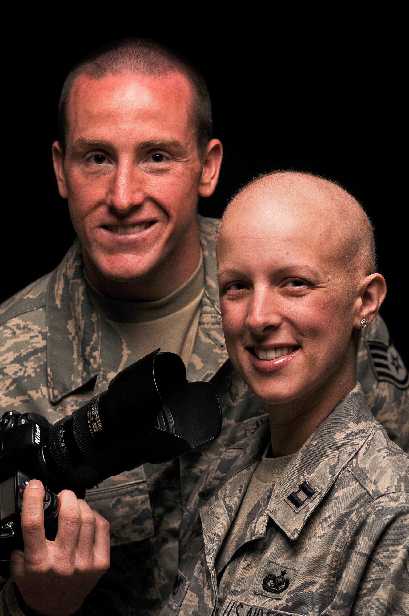 Staff Sgt. Russ Scalf and Capt. Candice Adams Ismirle pose for a studio photo April 8, 2011, at Fort George G. Meade, Md. 