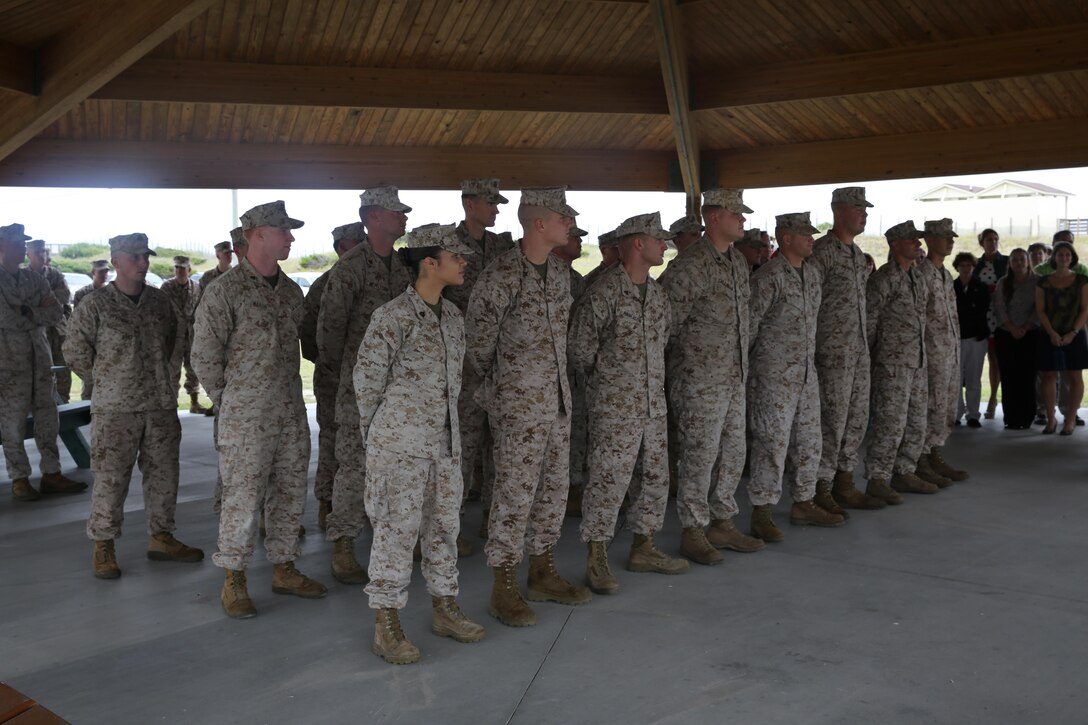 Marines with beach detachment, Company A, Headquarters and Support Battalion, stand in formation and await their awards presented by Marine Corps Community Services at Onslow Beach aboard Marine Corps Base Camp Lejeune, Oct. 16. The Marines successfully recovered eight swimmers during the summer months.
