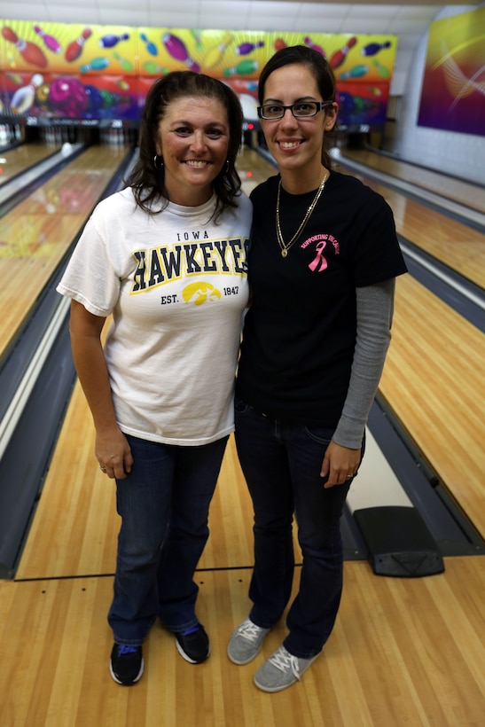 Angie Fredrickson and Aubrey Rethrage, the Nine-pin No Tap Tournament Women’s Division finalists, stand together after the tournament at the Bonnyman Bowling Center aboard Marine Corps Base Camp Lejeune, Oct. 19. Rethrage won the Women’s Division of the tournament. “I had a good feeling I was going to win,” Rethrage said. “I love bowling with Angie and Steve because we’re all friends and like to hangout.”