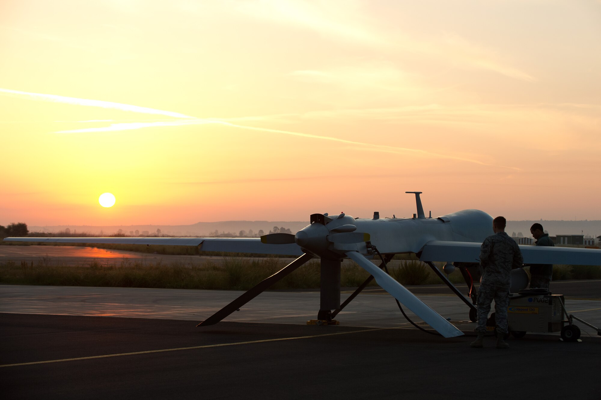 Airmen attached to the 324th Expeditionary Reconnaissance Squadron perform a preflight inspection on an MQ-1 Predator unmanned aerial vehicle Oct. 22, 2013. (U.S. Navy photo/Mass Communication Specialist 2nd Class Brian T. Glunt)