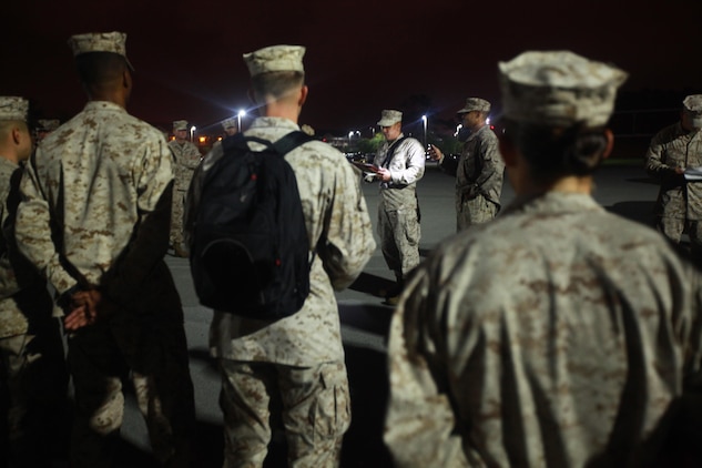 Marines from Marine Wing Support Squadron 274 form a school circle around Gunnery Sgt. Jose J. Cocco, the detachment chief, as he calls roll to make sure everyone departing for Integrated Training Exercise is present. MWSS-274 Marines will be in Twentynine Palms, Calif. for approximately five weeks participating in and supporting ITX.