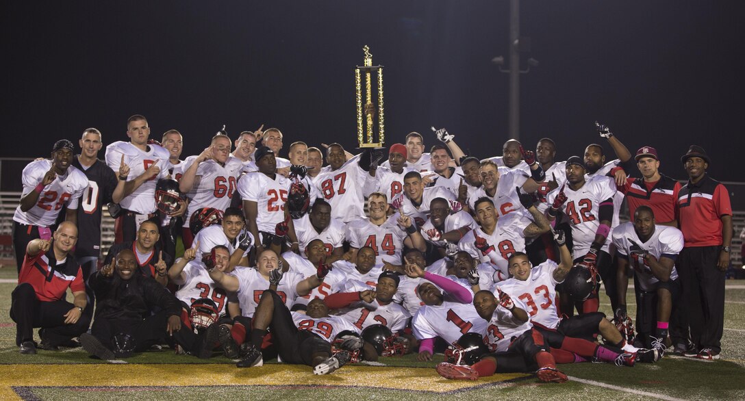 The Marine Corps Air Station Miramar Falcons raise the Gold Division trophy at Paige Field House aboard Marine Corps Base Camp Pendleton, Calif., Oct. 22.  Miramar played the 11th Marine Cannon Cockers and came out on top with a 34-0 win, finishing the regular season with a 7-1 record.