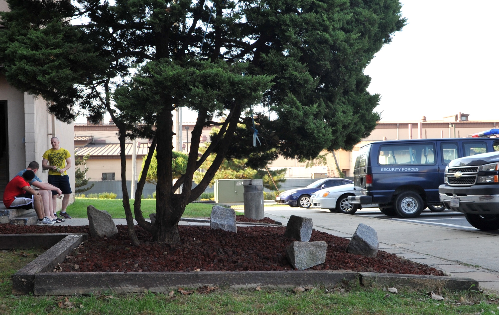 Airmen enjoy the new landscaping around Bldg. 1436 after a “Worst Dorm First” renovation at Osan Air Base, Republic of Korea, Oct. 23, 2013. Lava rock beds now line the entire exterior of the dorm. (U.S. Air Force photo/Airman 1st Class Ashley J. Thum)