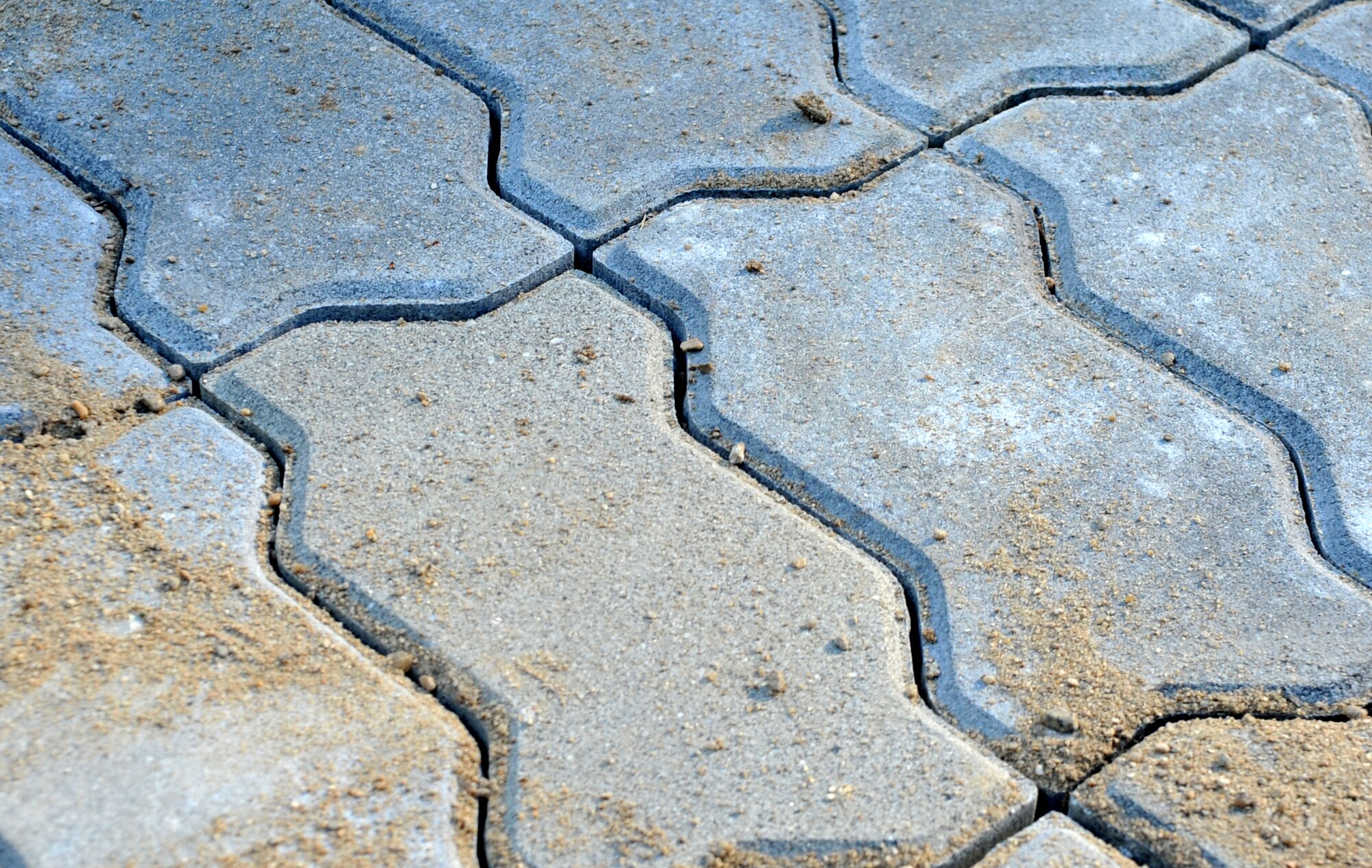 Freshly-laid bricks forming the new patio area behind Bldg. 1436 wait to feel the footsteps of lounging Airmen at Osan Air Base, Republic of Korea, Oct. 23, 2013. The 51st Civil Engineer Squadron “Dirt Boys,” along with dorm residents, used two pallets of the bricks to create the patio and frame lava rock beds around the building. (U.S. Air Force photo/Airman 1st Class Ashley J. Thum)
