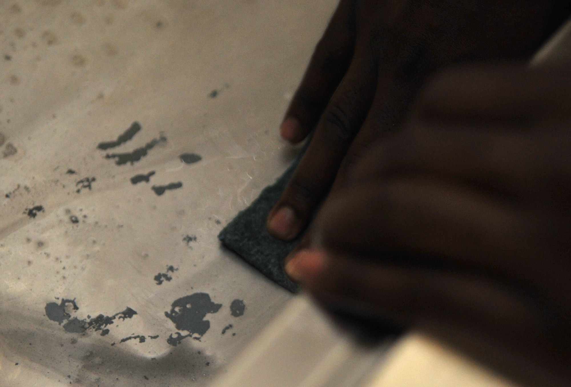 Airman 1st Class Jacorey Craft, 51st Security Forces Squadron patrolman, cleans a sink in one of Bldg. 1436’s dayrooms at Osan Air Base, Republic of Korea, Oct. 23, 2013. The dayroom was one of many areas of the building given a facelift during this portion of the “Worst Dorm First” program. (U.S. Air Force photo/Airman 1st Class Ashley J. Thum)