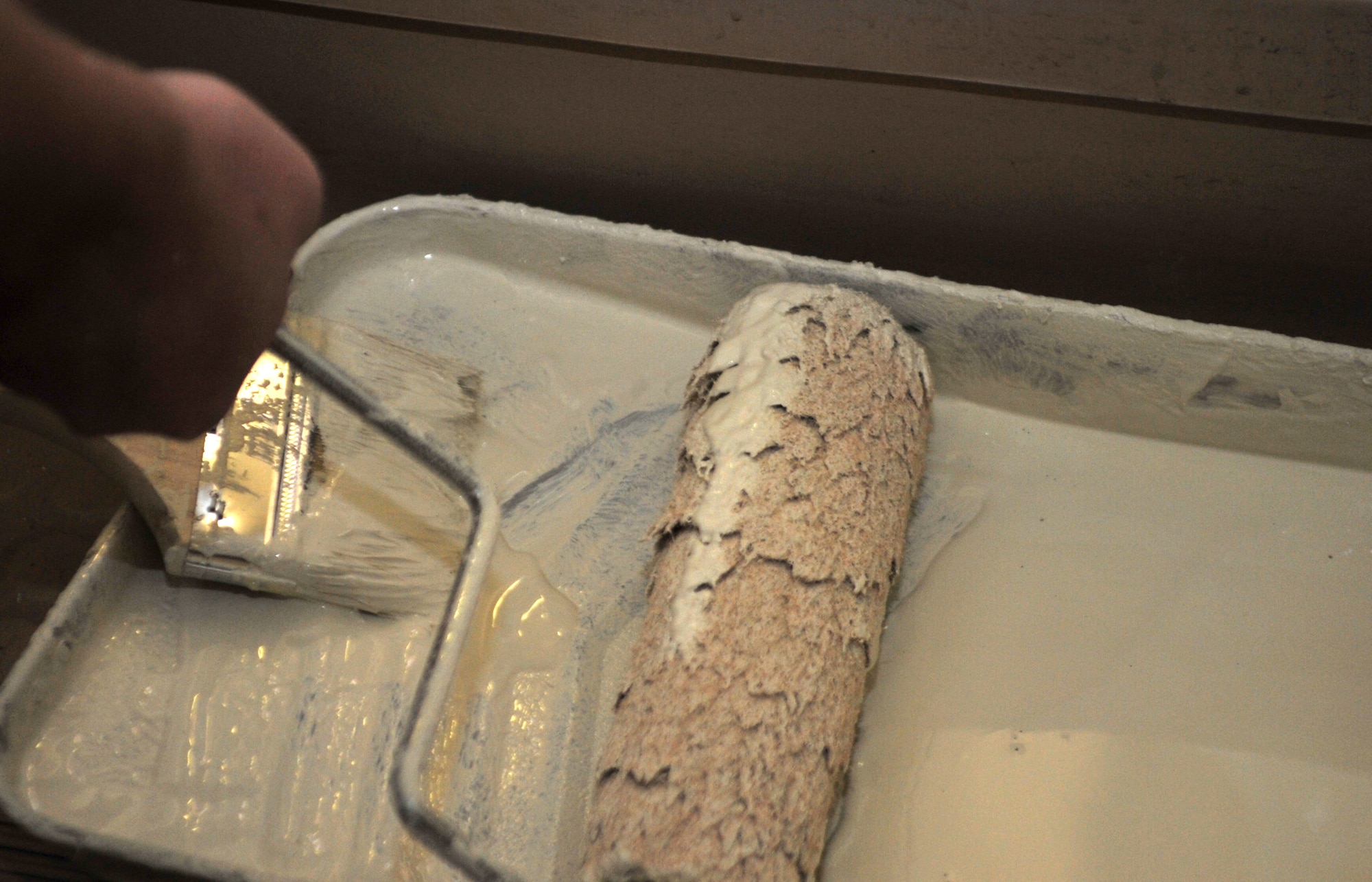 Senior Airman Matthew Prichard, 51st Security Forces Squadron area supervisor, wets a paint roller with paint in Bldg. 1436 at Osan Air Base, Republic of Korea, Oct. 23, 2013. The “Worst Dorm First” campaign aims to renovate all of Osan’s dorms, one per month, alternating between NCO and Airman living quarters. (U.S. Air Force photo/Airman 1st Class Ashley J. Thum)