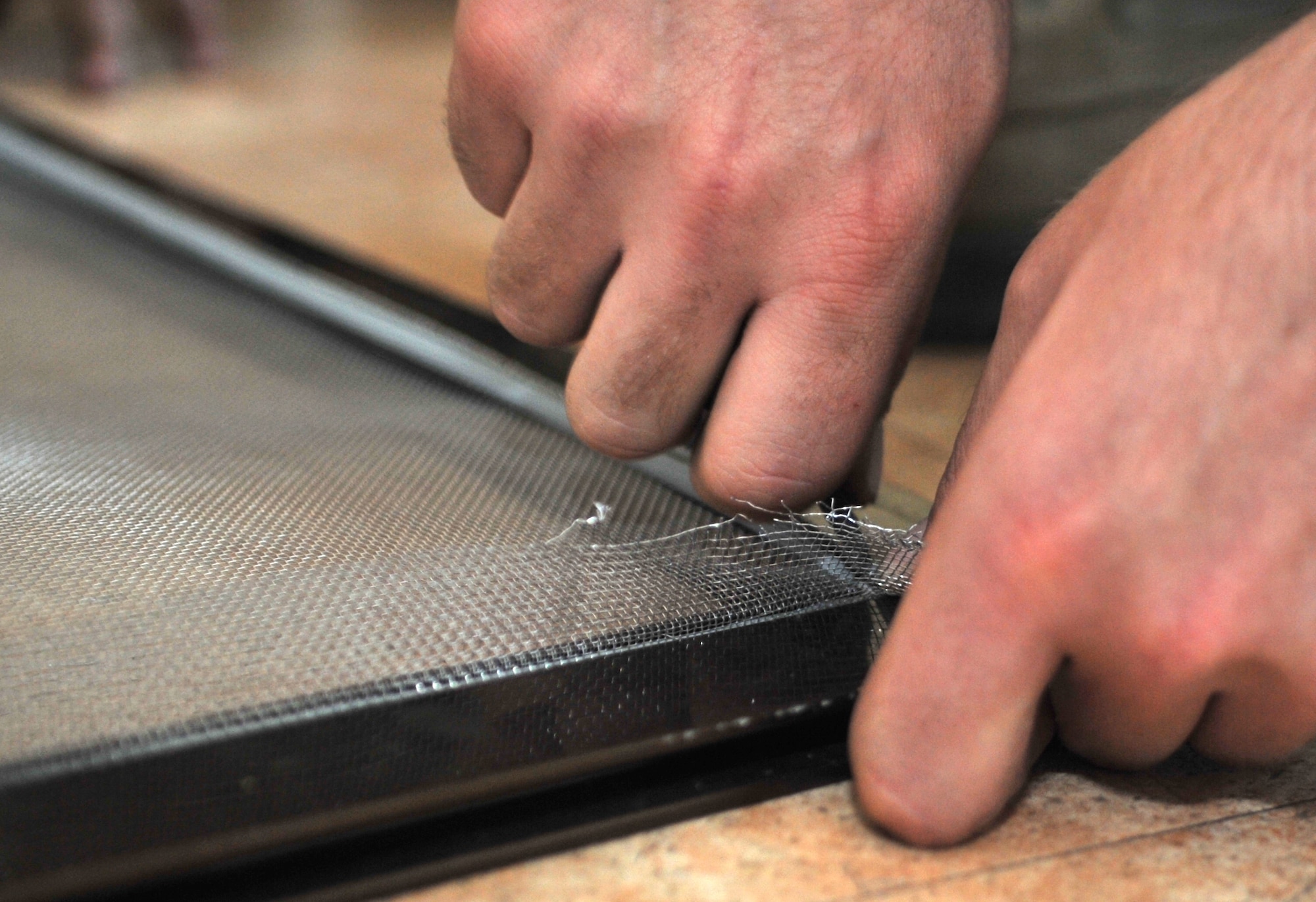 Airman 1st Class Zackery Stroup, 51st Security Forces Squadron force protection member, places a polyvinyl chloride seal in the frame of a window while re-screening it in Bldg. 1436 at Osan Air Base, Republic of Korea, Oct. 23, 2013. This was the second wave of Airman dorm renovations for the 51st Civil Engineer Squadron Airman Dorm Leaders’ “Worst Dorm First” program. (U.S. Air Force photo/Airman 1st Class Ashley J. Thum)