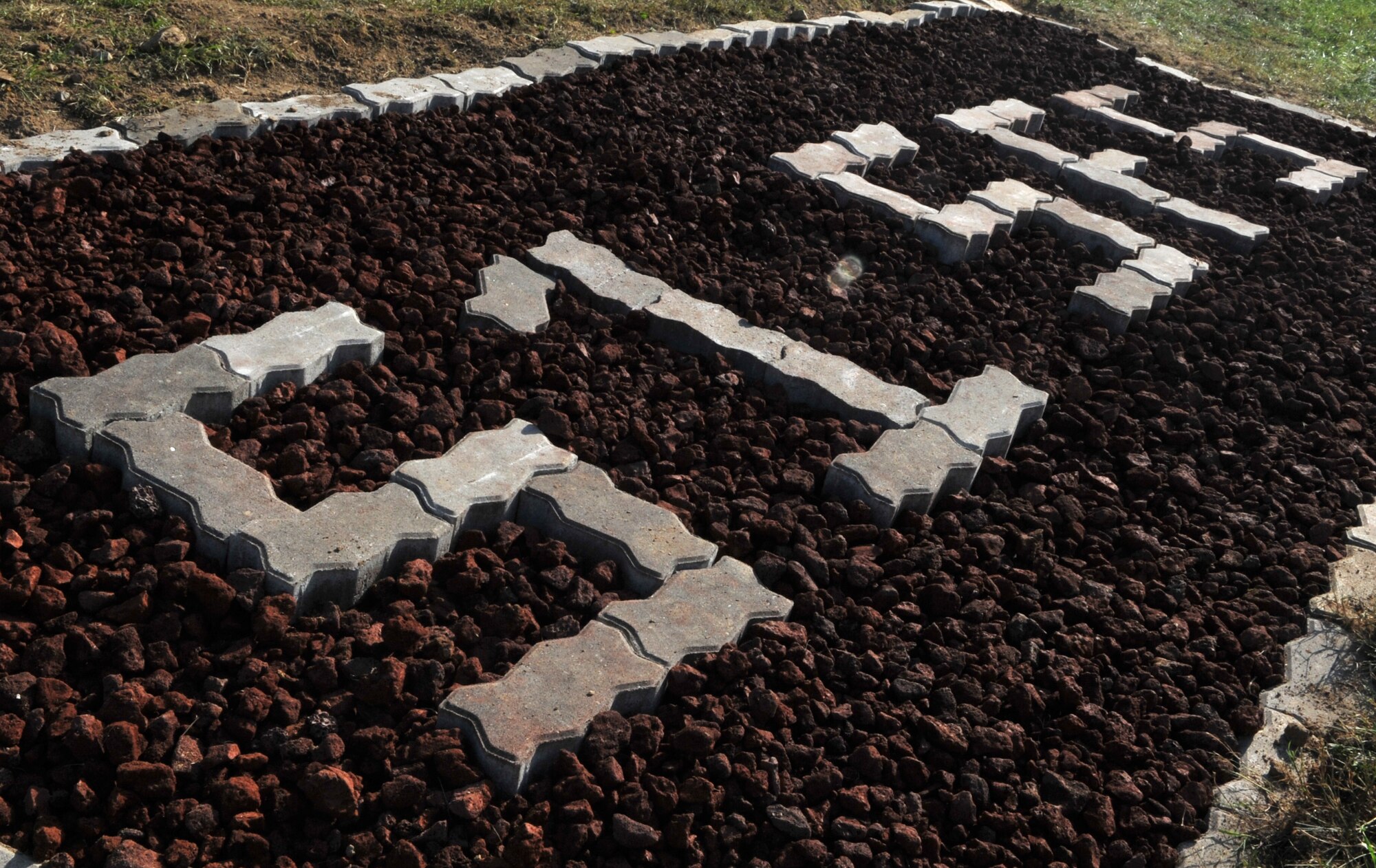 A lava rock bed in front of Bldg. 1436 clearly identifies it as home to members of the 51st Security Forces Squadron at Osan Air Base, Republic of Korea, Oct. 23, 2013. The marker is one of many renovations the building received during a one-day transformation as part of the “Worst Dorm First” campaign. (U.S. Air Force photo/Airman 1st Class Ashley J. Thum)