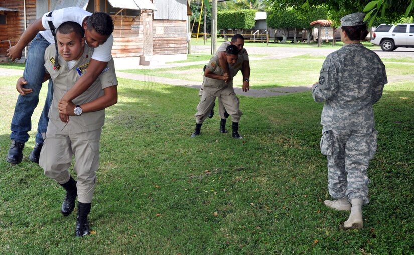 Honduran firefighters evacuate"victims" as part of a basic life support class conducted at Soto Cano Air Base, Honduras, Oct. 23, 2013.  Members of Joint Task Force-Bravo's Medical Element (MEDEL) trained 19 local firefighters in basic life support skills.  (U.S. Air Force photo by Capt. Zach Anderson)