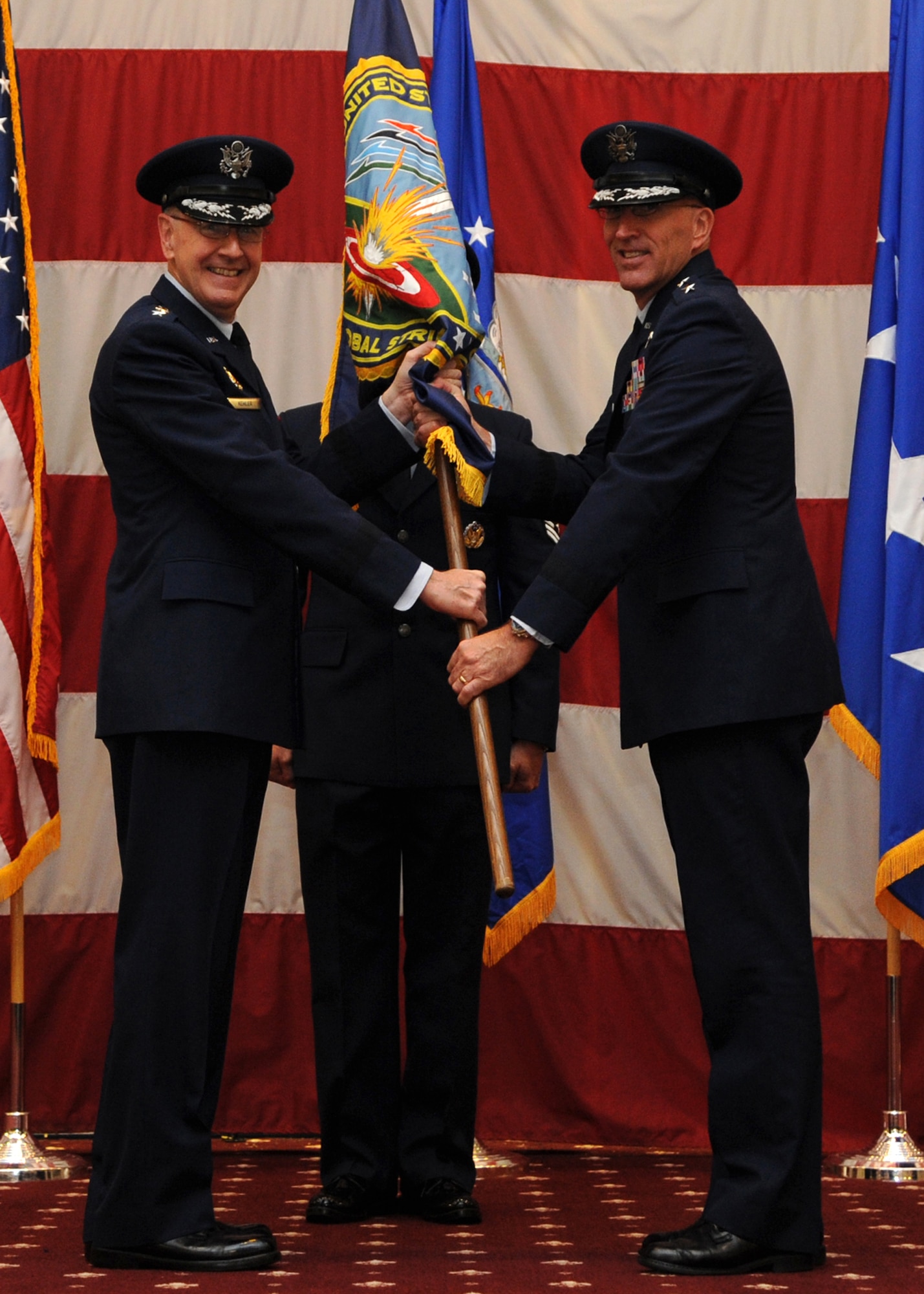 Commander of U.S. Strategic Command Gen. C. Robert Kehler presents a guidon to Maj. Gen. Scott Vander Hamm, the new Joint Functional Component Commander for Global Strike, and Task Force 204 commander, during a promotion and change of ceremony at Barksdale Air Force Base, La., Oct. 23, 2013. (U.S. Air Force photo/Senior Airman Joseph A. Pag?n Jr.)