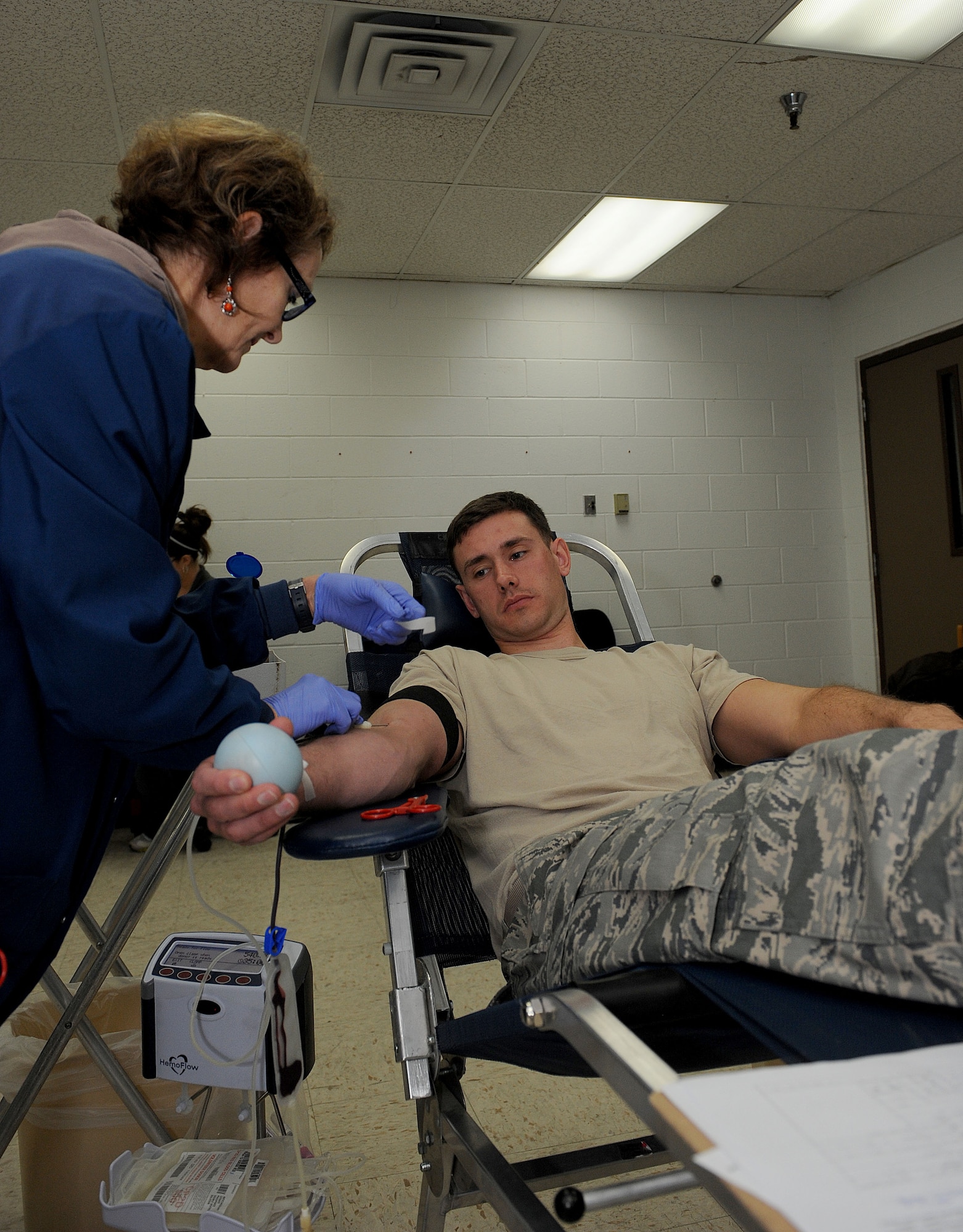 Senior Airman Christopher Dye, 28th Aircraft Maintenance Squadron B-1 Bomber crew chief, donates blood during a blood drive conducted by United Blood Services in the 28th Maintenance Squadron at Ellsworth Air Force Base, S.D., Oct. 18, 2013. Blood collected by UBS is stored in  the local area, supplying blood to those in need including accident victims and others needing transfusions. (U.S. Air Force Photo by Airman 1st Class Rebecca Imwalle/ Released)