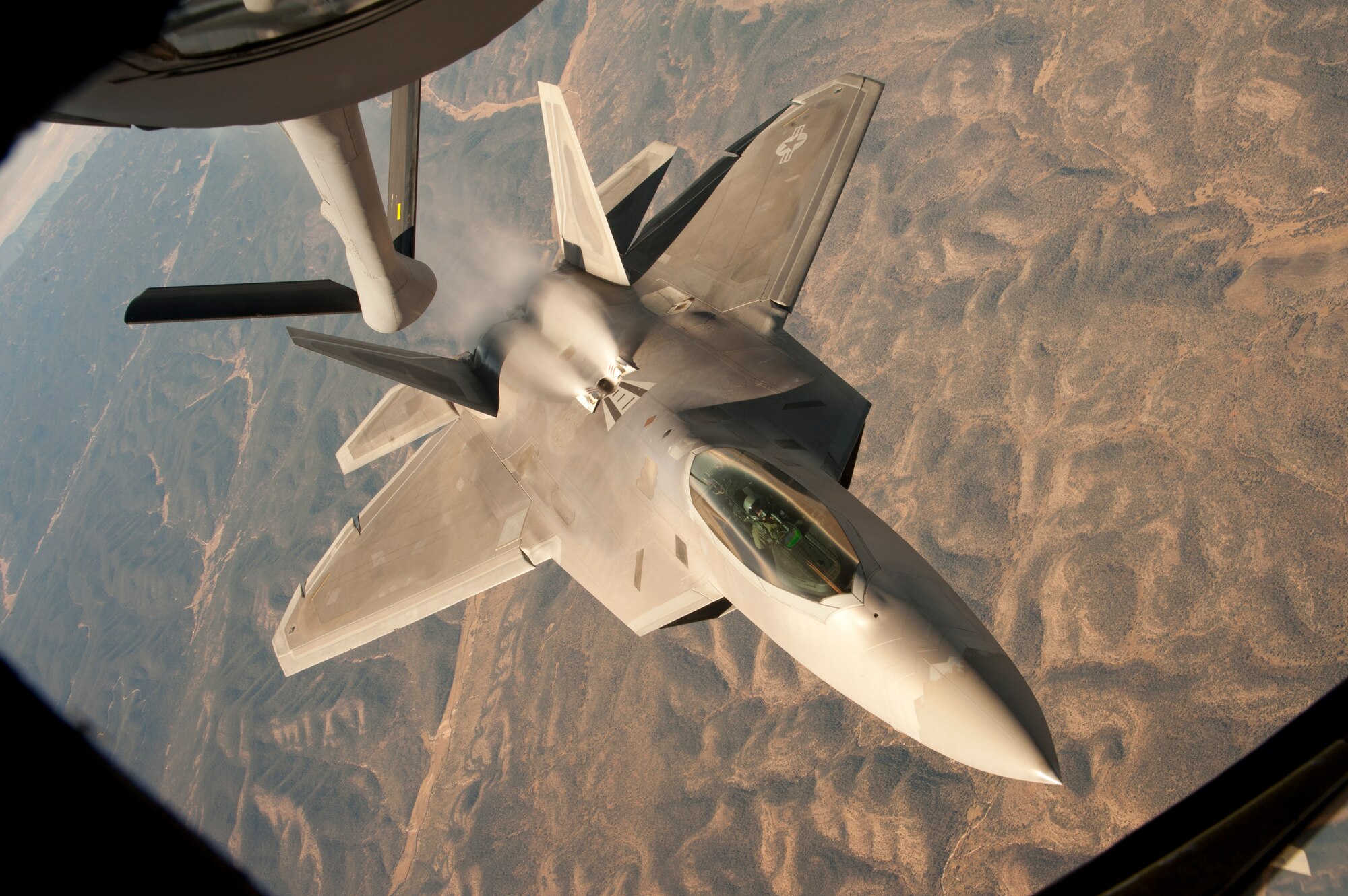 An F-22 Raptor assigned to the 49th Fighter Wing, at Holloman Air Force Base, N.M., backs away from a KC-135 Stratotanker from McConnell Air Force Base, Kan., Oct. 23, 2013. Four Raptors were refueled over central New Mexico during this training mission. (U.S. Air Force photo/Airman 1st Class John Linzmeier)