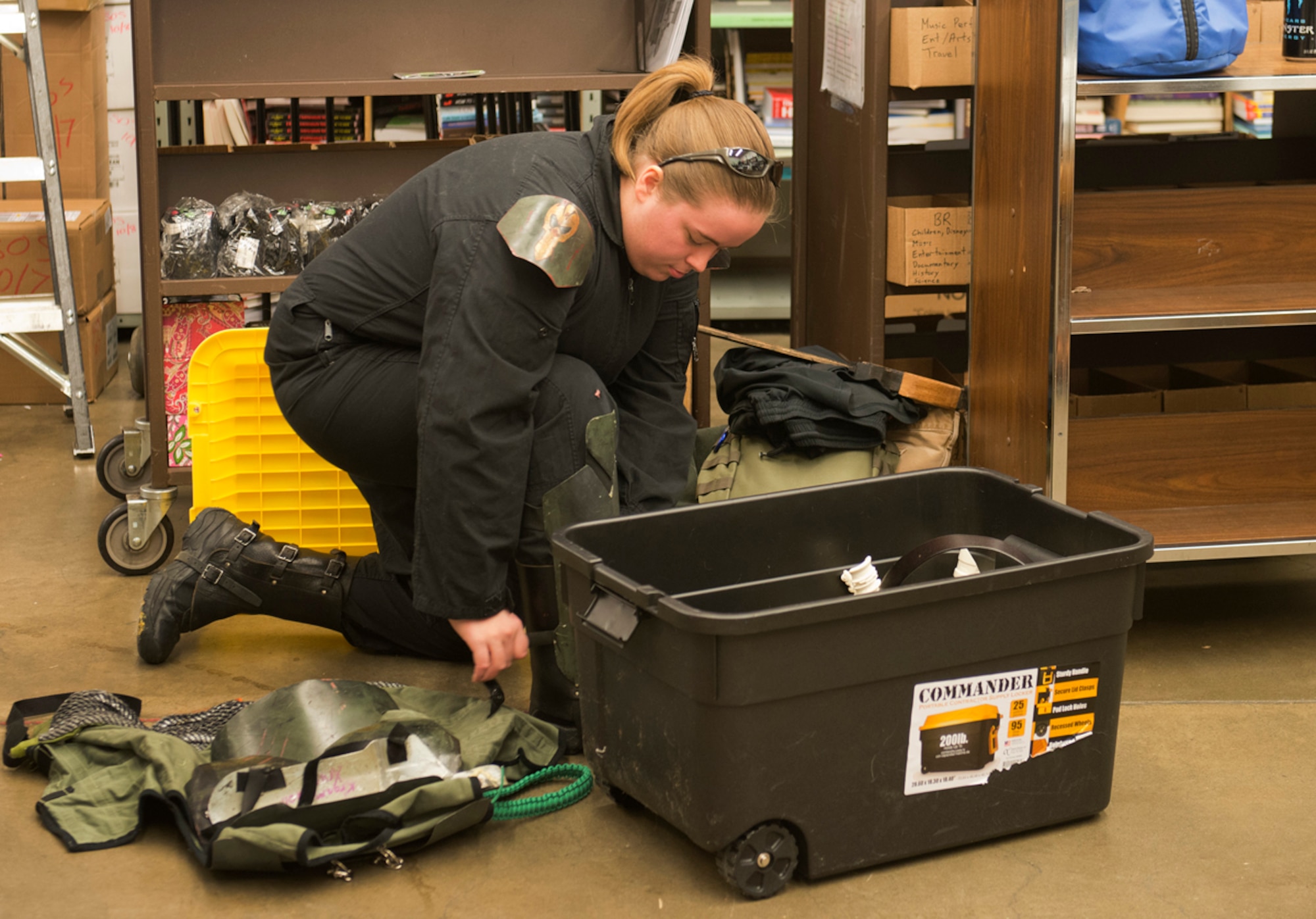 Jade Pardue, a member of the 501st Legion, Vader's Fist, prepares her bounty hunter costume at Barnes & Noble in Anchorage Oct. 5. Members of the legion attended the second annual Star Wars Reads Day to encourage kids and adults to read. (U.S. Air Force photo/Staff Sgt. Zachary Wolf)