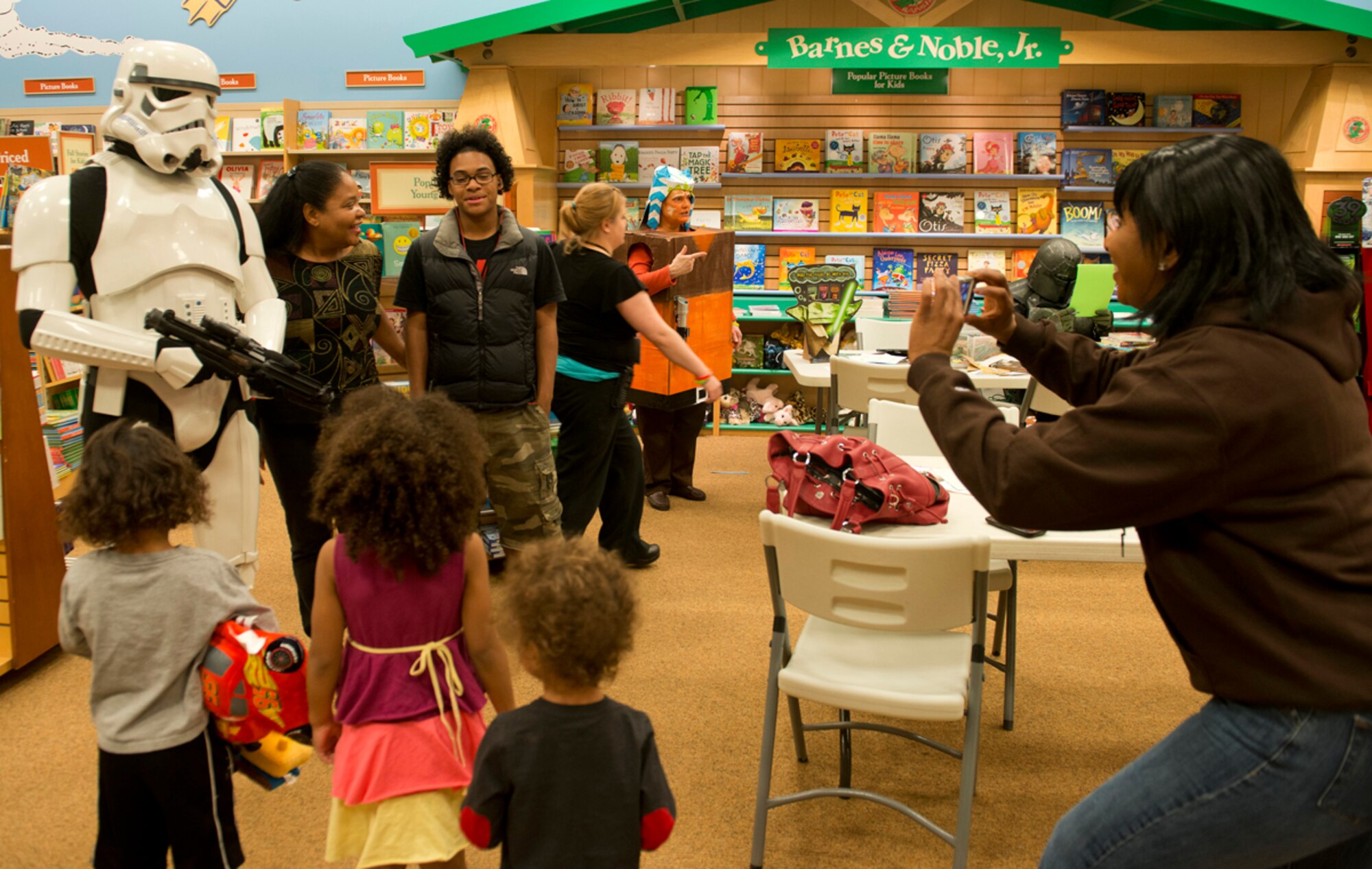 Family members take photos with a Storm Trooper from the 501st Legion, Vader's Fist, at Barnes & Noble during Star Wars Reads Day Oct. 5. Members of the legion attended the second annual Star Wars Reads Day to encourage kids and adults to read. (U.S. Air Force photo/Staff Sgt. Zachary Wolf)