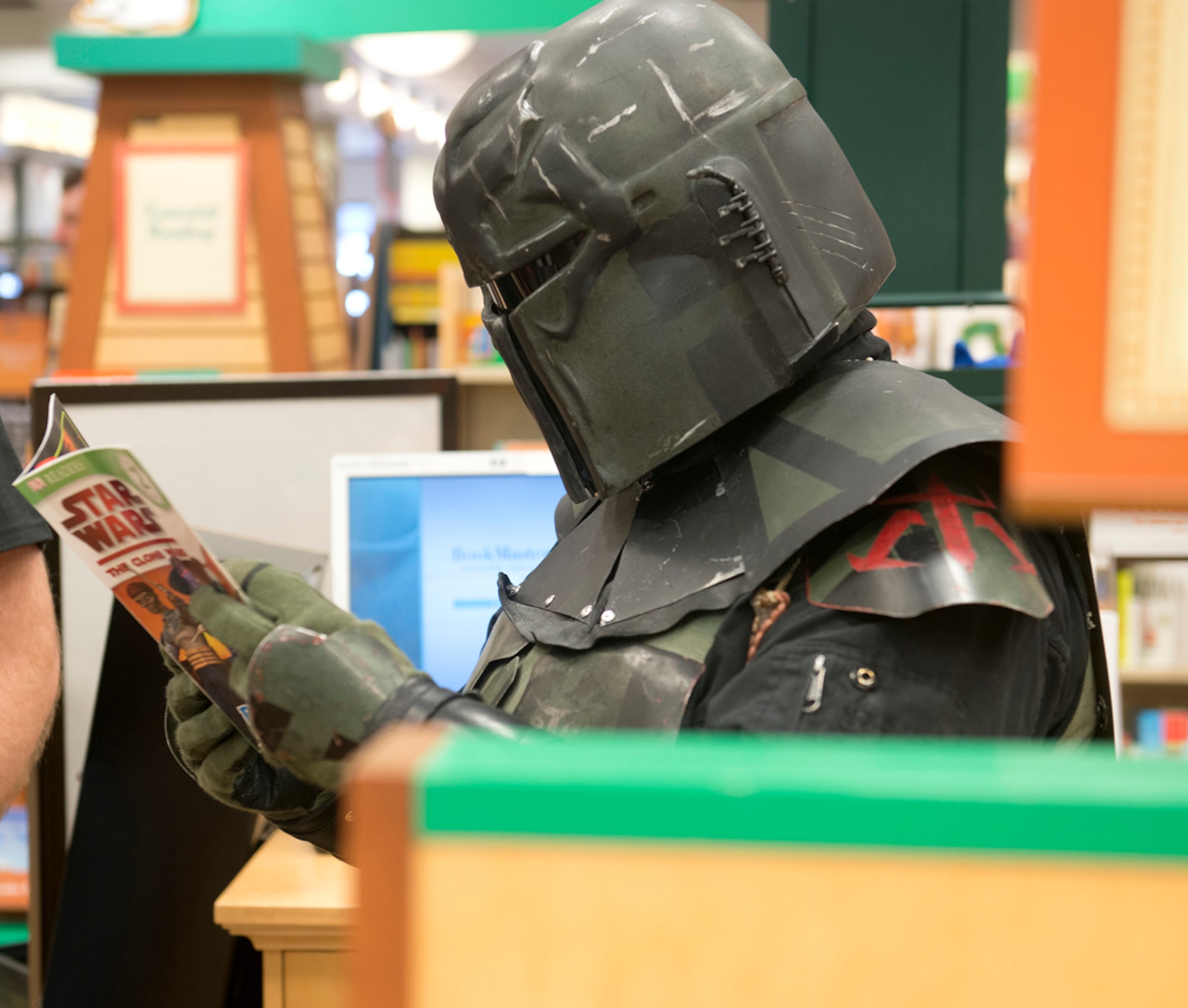 Jade Pardue, a member of the 501st Legion, Vader's Fist, reads a Star Wars book at Barnes & Noble in Anchorage Oct. 5. Members of the legion attended the second annual Star Wars Reads Day to encourage kids and adults to read. (U.S. Air Force photo/Staff Sgt. Zachary Wolf)