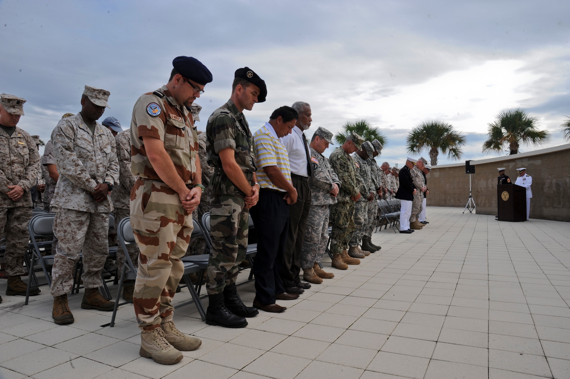 More than 100 military members from both U.S. and coalition forces, Beirut veterans, and family members of those whose lives were taken stand during an invocation at the Beirut memorial observance at MacDill Air Force Base, Fla., Oct. 23, 2013. The memorial observance was held at the U.S. Central Command memorial. (U.S. Air Force photo by Airman 1st Class Ned T. Johnston/Released)