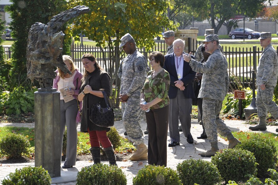 Col. John M. Devillier, Air Force Mortuary Affairs Operations commander, highlights the Angel and the Dying Unknown sculpture outside the Center for Families of the Fallen, Dover Air Force Base, Del., during an open house the mortuary hosted Oct. 22, 2013 for Team Dover. (U.S. Air Force photo/Senior Airman Laura Beckley) 