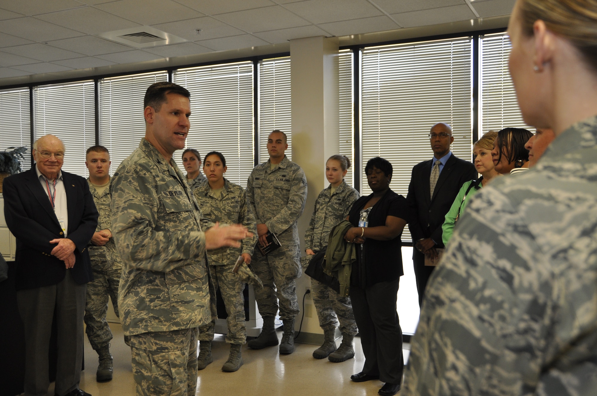 Col. John M. Devillier, Air Force Mortuary Affairs Operations commander, shows members from Team Dover the command, control and communications center at the Charles C. Carson Center for Mortuary Affairs, Dover Air Force Base, Del., during an open house Oct. 22, 2013. (U.S. Air Force photo/Senior Airman Laura Beckley) 